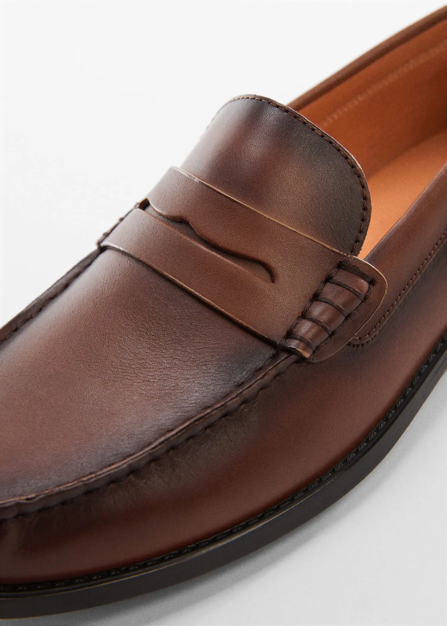 Mango Leather penny loafers. a close-up view of a brown loafer shoe. 