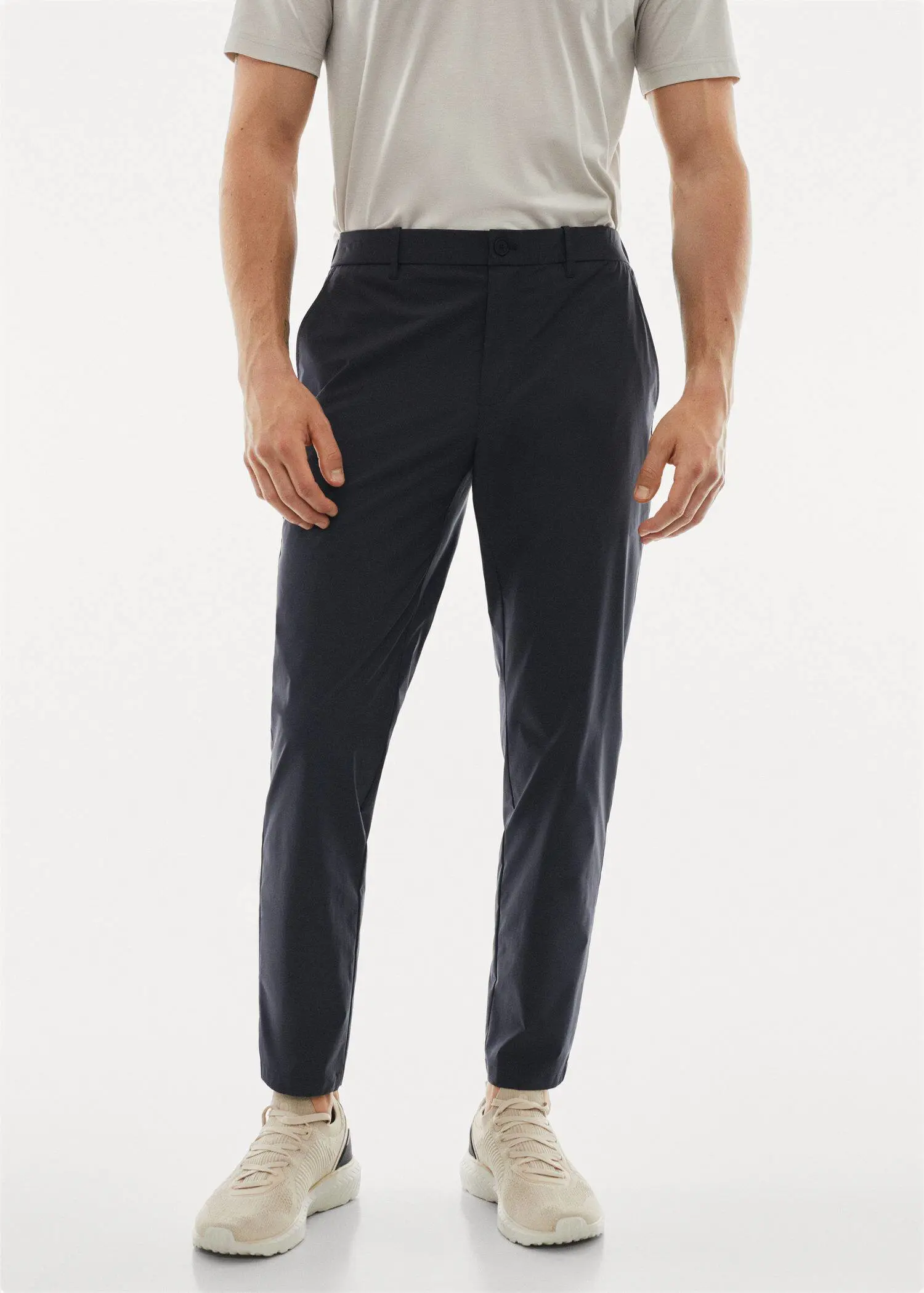 Mango Water-repellent technical trousers. a man wearing a pair of black dress pants. 
