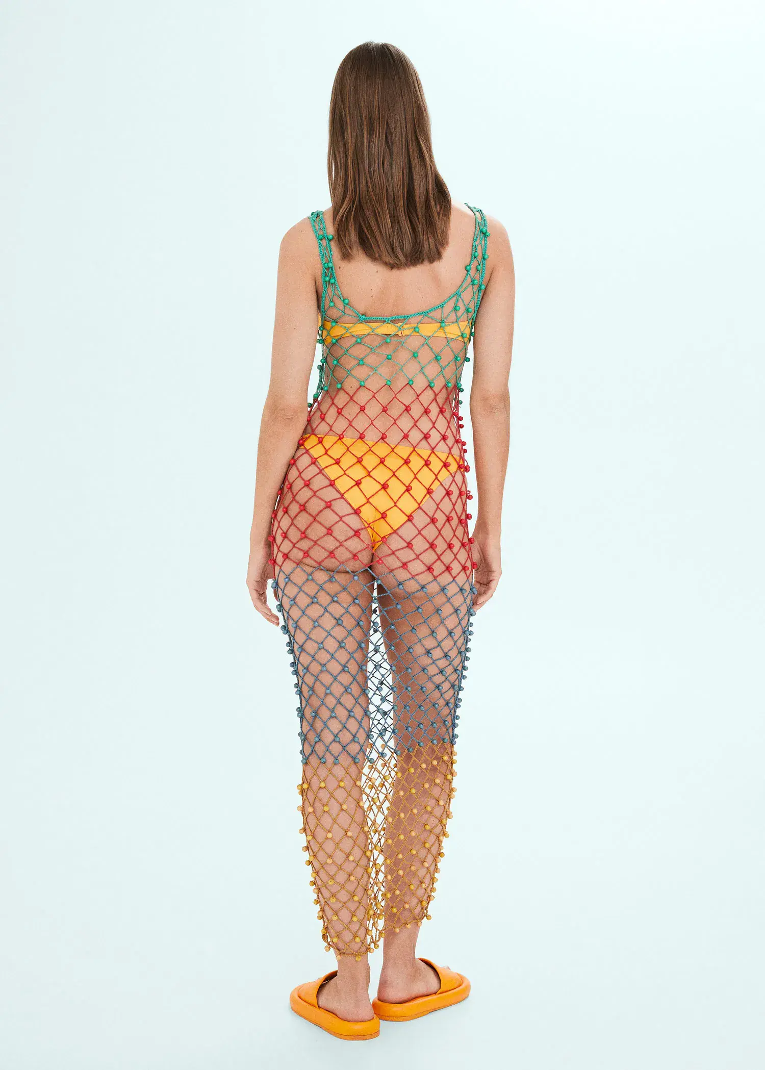 Mango Multi-colored net dress with beads. a woman wearing a colorful fishnet outfit. 
