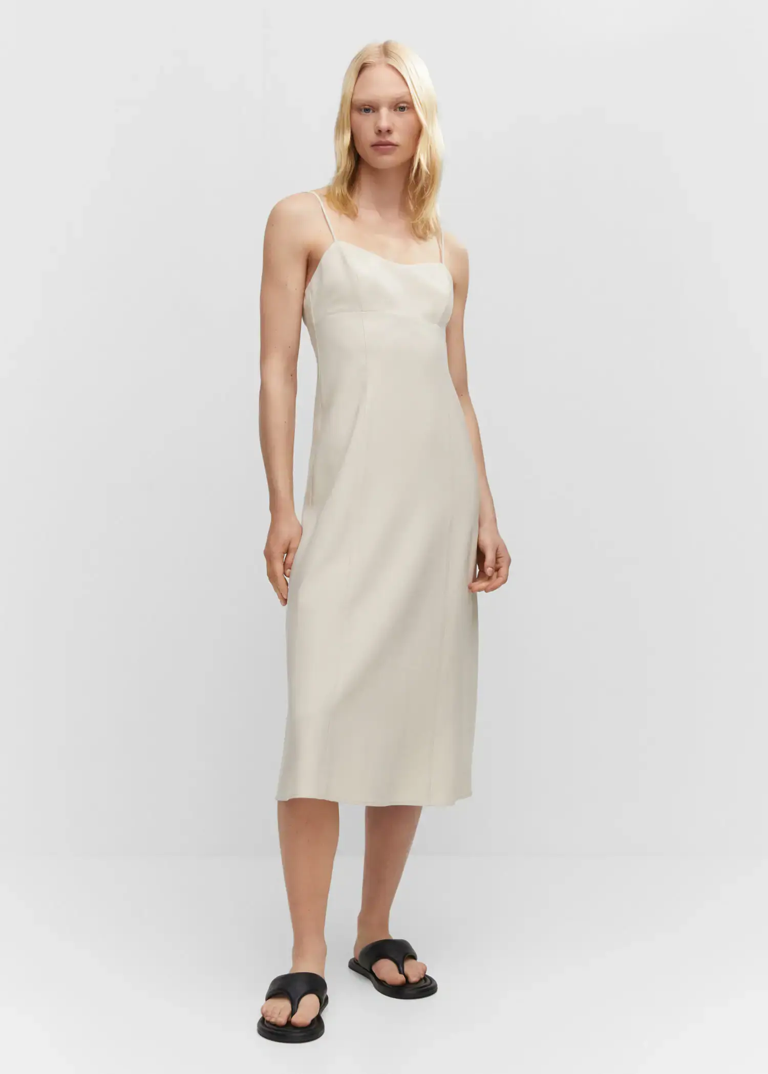 Mango Low-cut midi-dress. a woman in a white dress standing in front of a white wall. 