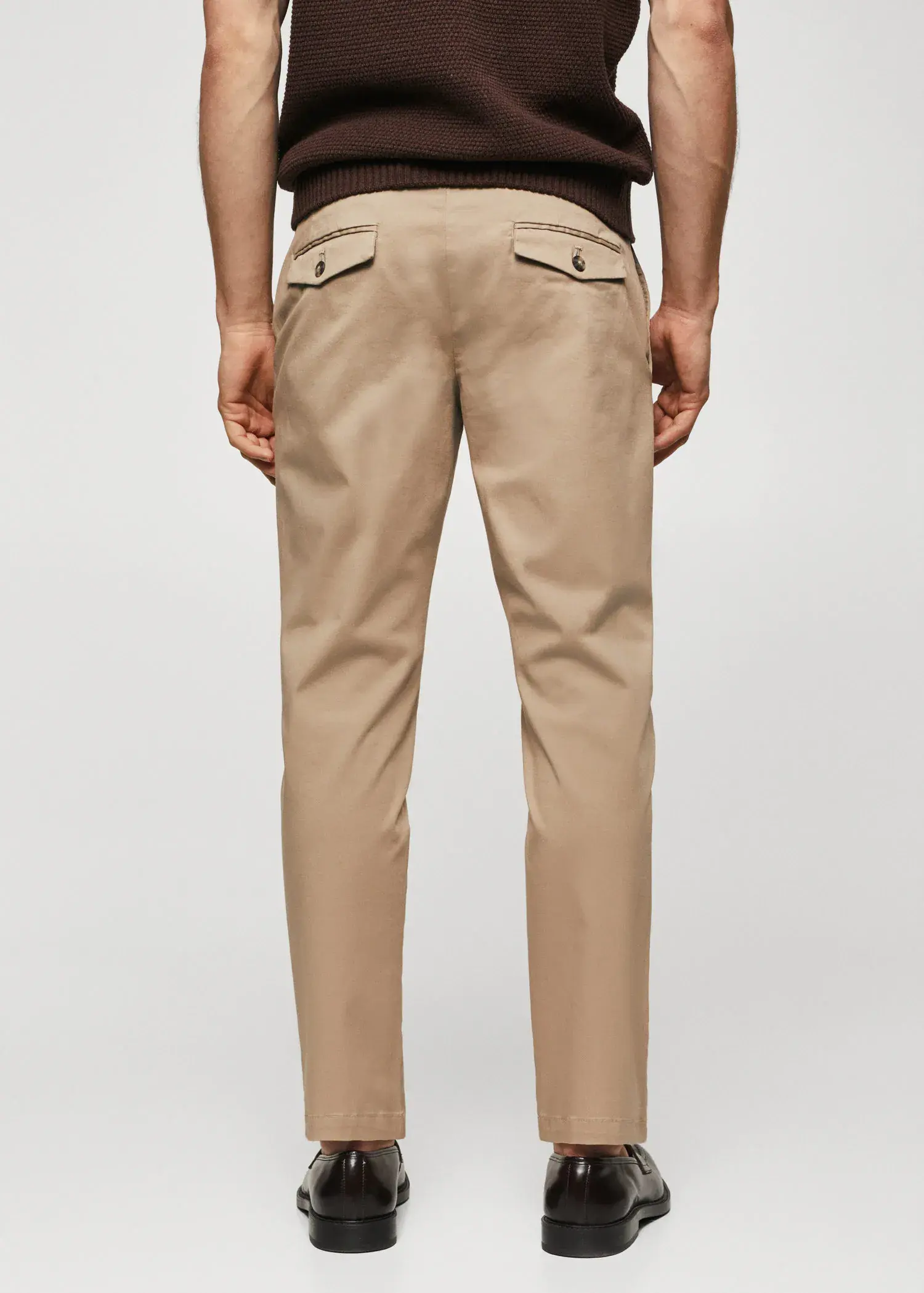 Mango Cotton tapered crop pants. a man wearing a tan pair of chinos. 