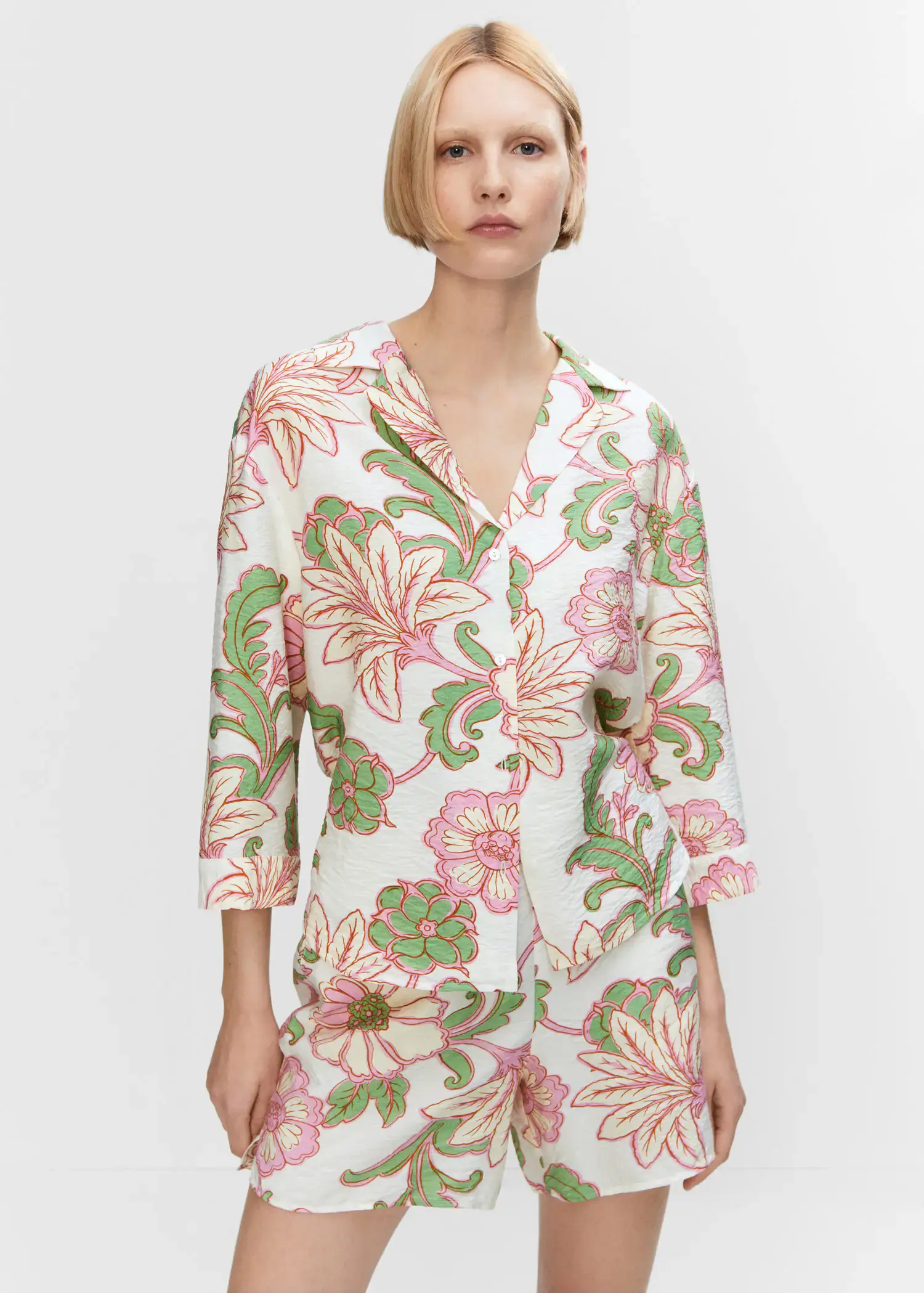 Mango Textured printed shirt. a woman in a floral print shirt and shorts. 