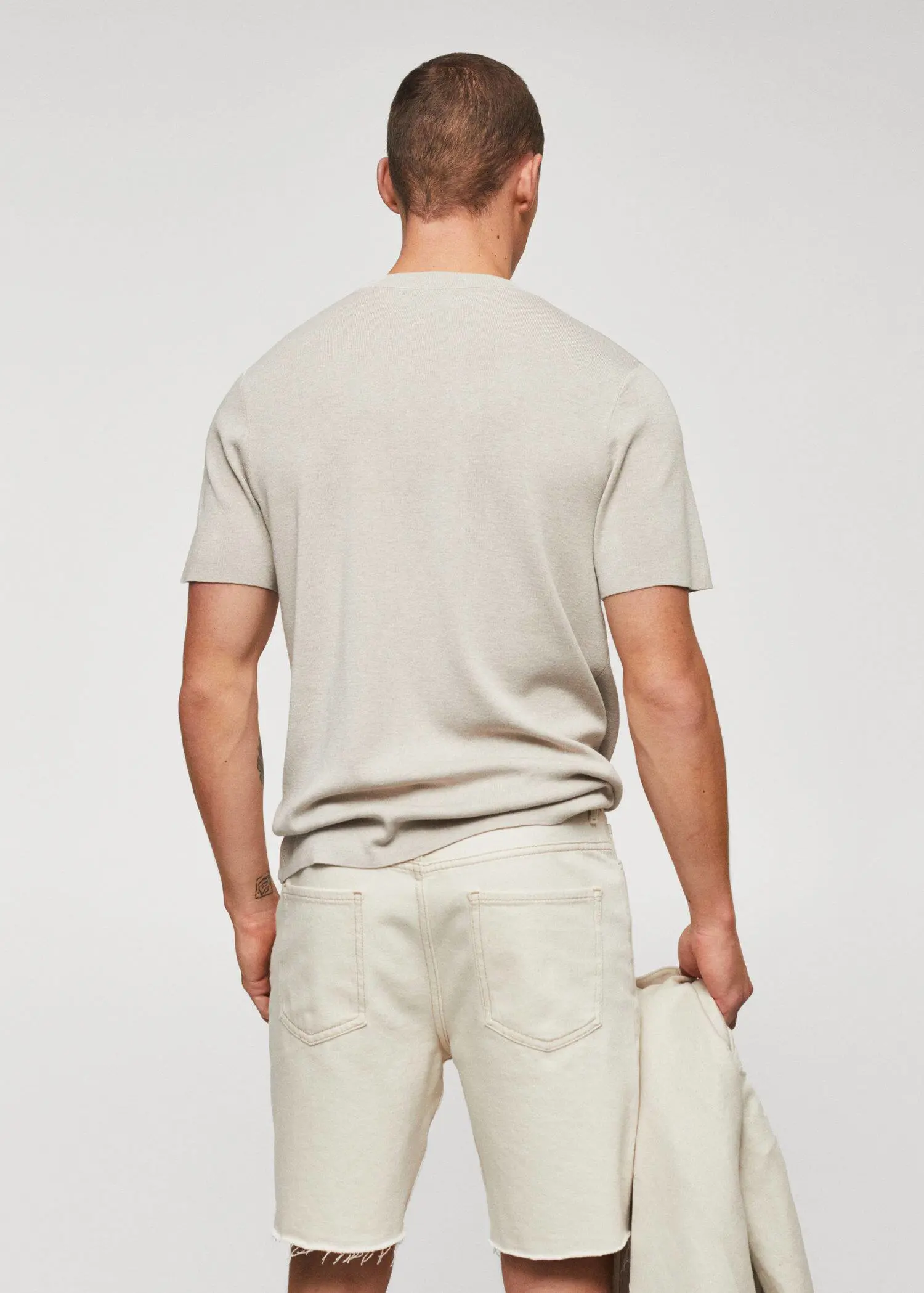 Mango Cotton fine-knit t-shirt. a man wearing white shorts and a white shirt. 
