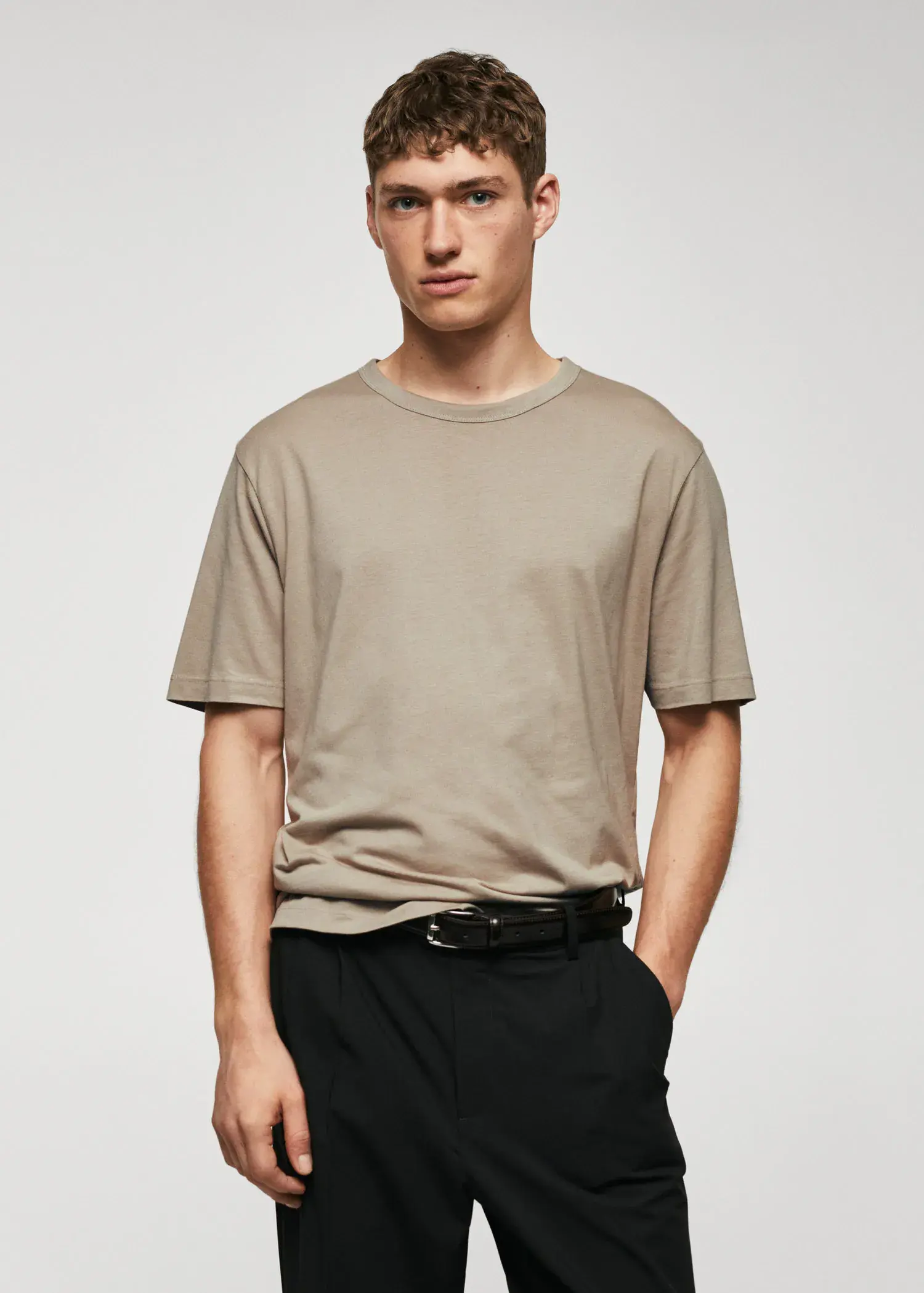 Mango Basic mercerized lightweight shirt. a young man wearing a tan t-shirt and black pants. 
