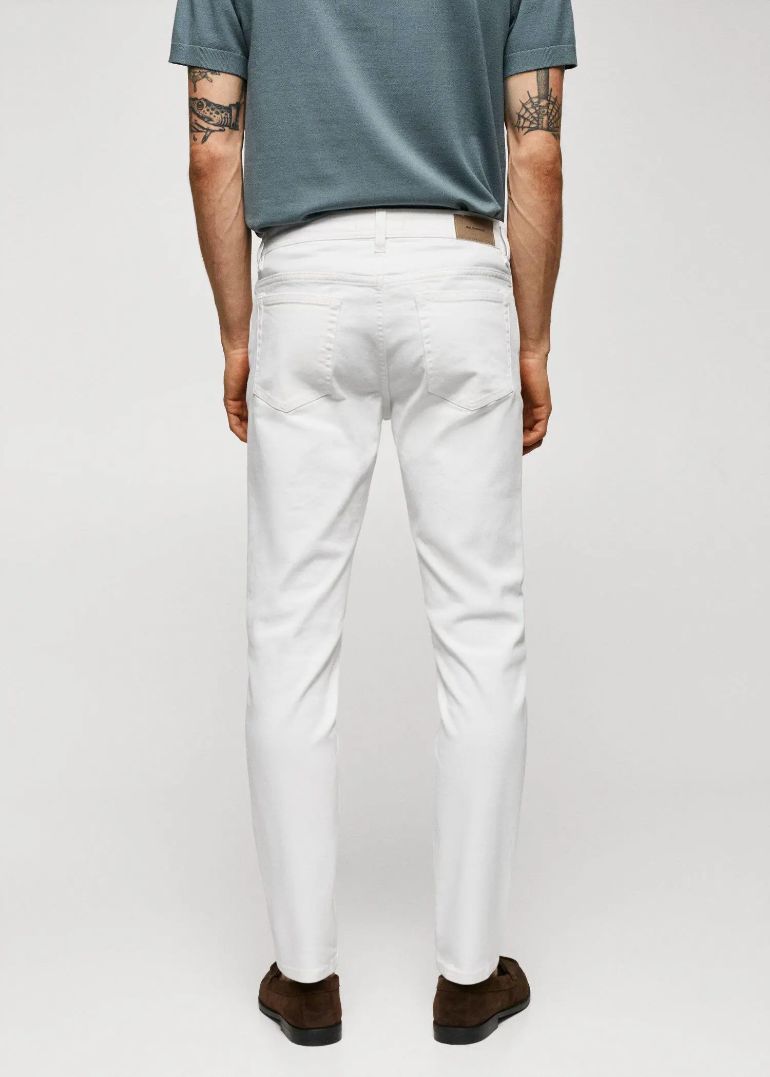Mango Jan slim-fit jeans. a man wearing white pants and a green shirt. 
