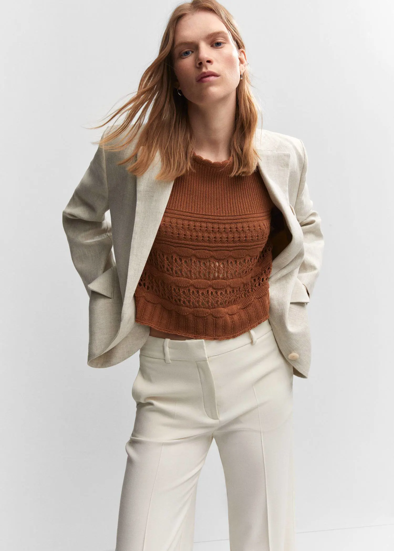 Mango Openwork sweater with flared sleeves. a woman wearing a brown sweater and white pants. 