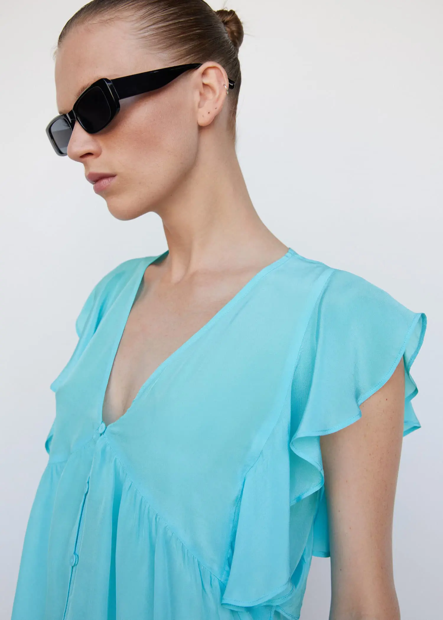Mango Ruffled blouse. a close up of a person wearing sunglasses 