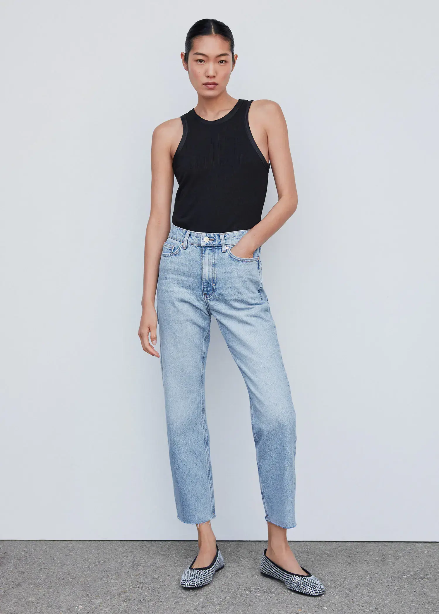 Mango High waist straight jeans. a woman in a black shirt and jeans. 