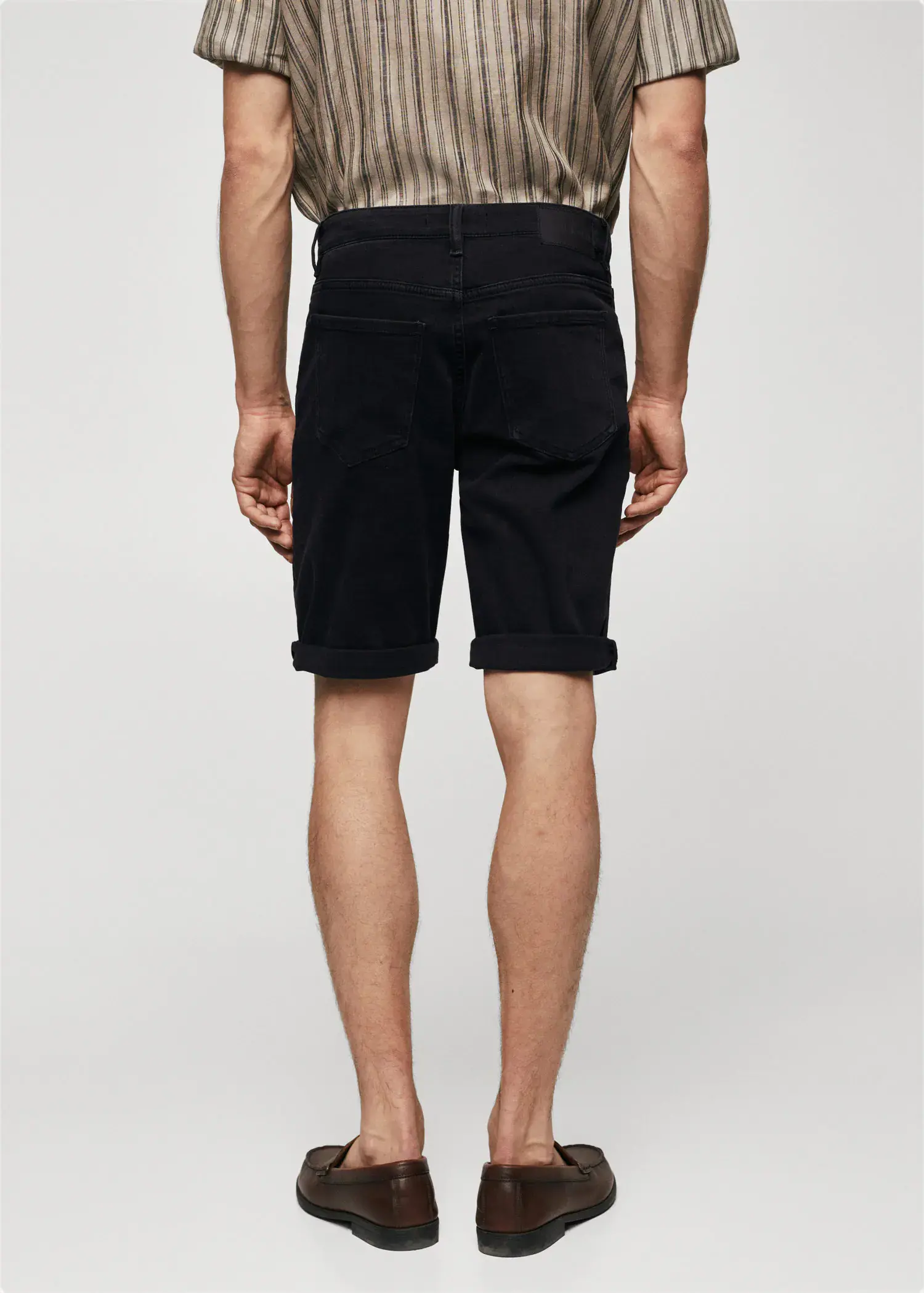 Mango Slim-fit denim bermuda shorts. a man in black shorts and a white shirt. 