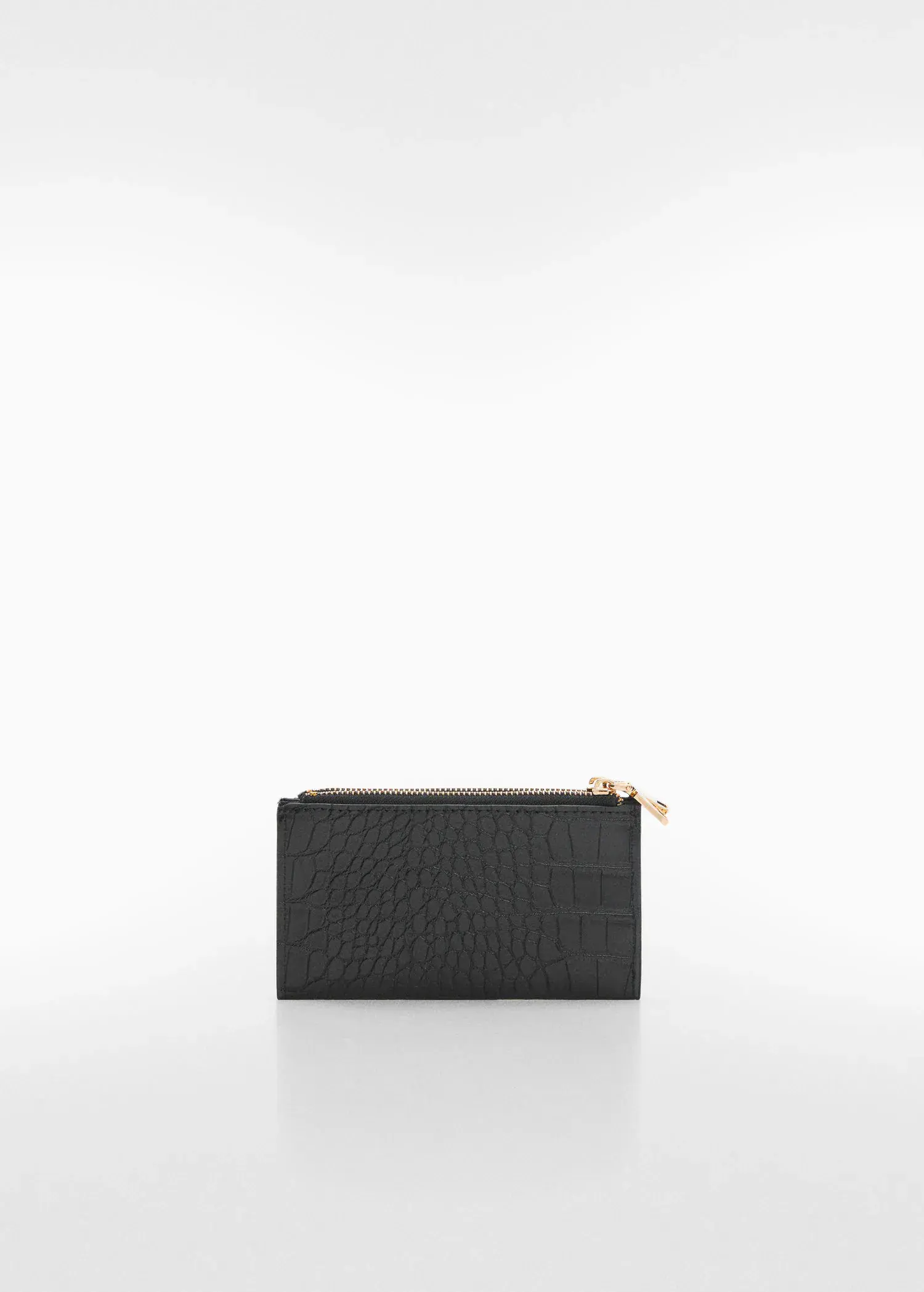 Mango Crocodile purse with logo. a black purse sitting on top of a white table. 