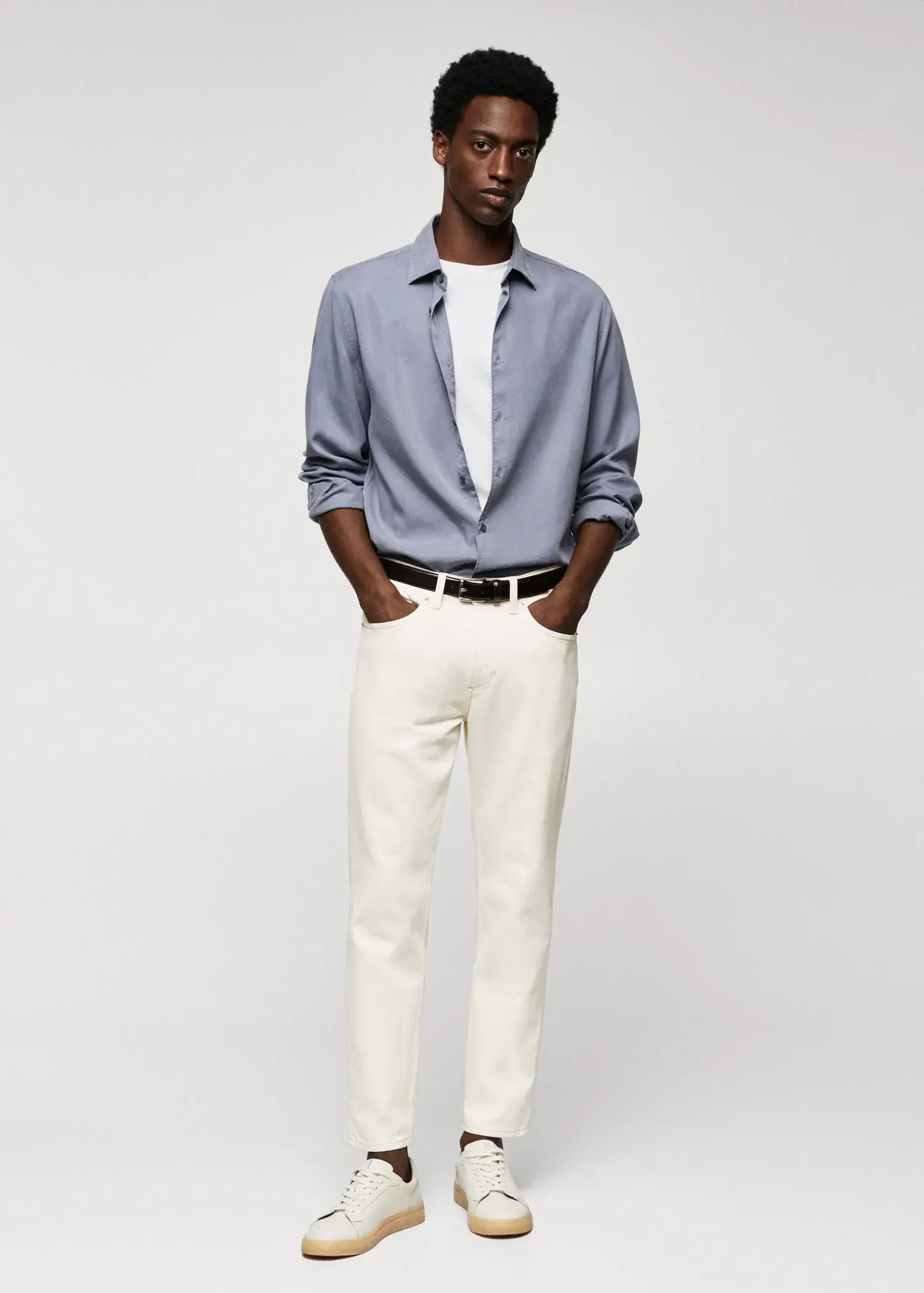 Mango Ben tapered cropped jeans. a man in a blue shirt and white pants. 