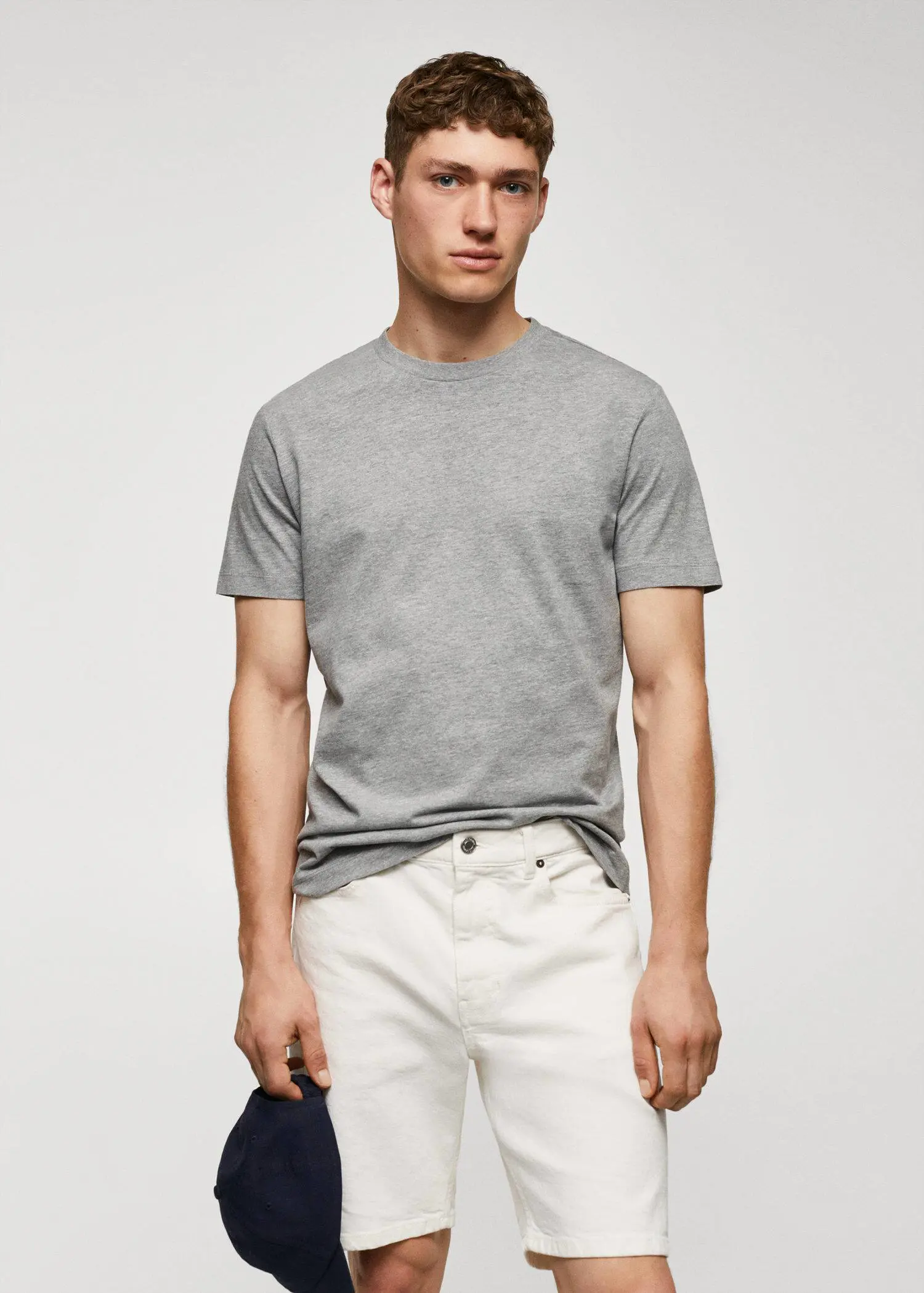Mango Basic cotton stretch T-shirt. a man wearing white pants and a gray t-shirt. 