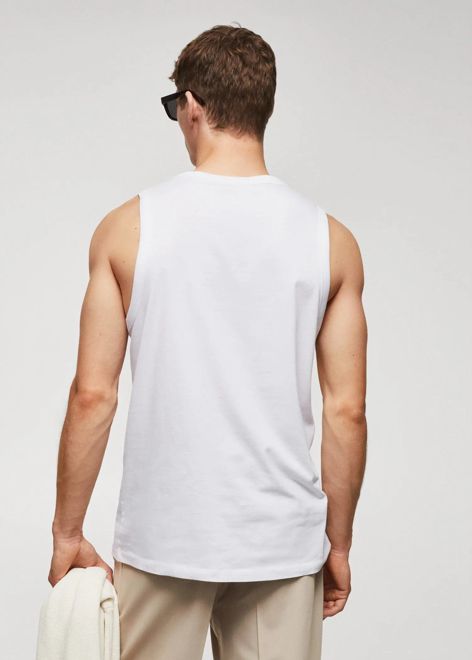 Mango Strap cotton T-shirt. a man wearing a white shirt and sunglasses. 