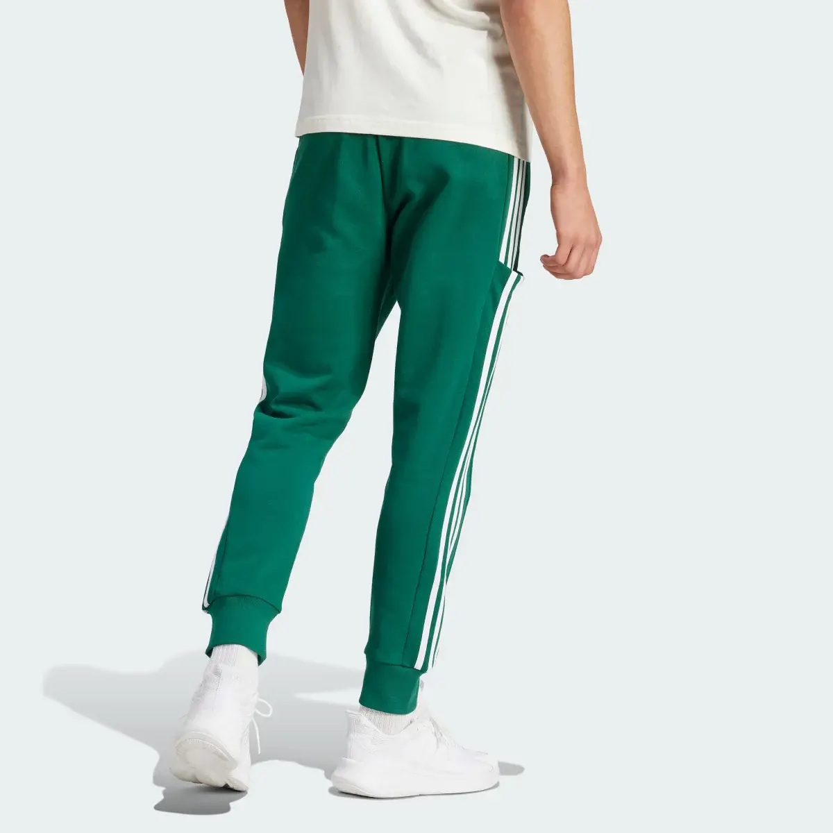 Adidas Pantaloni Essentials French Terry Tapered Cuff 3-Stripes. 2