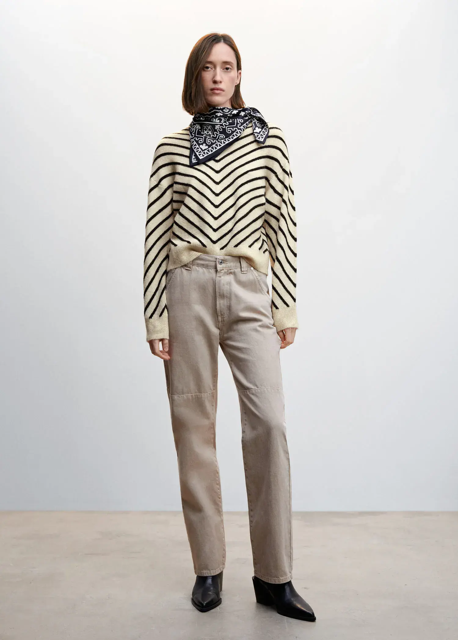 Mango Stripe-print sweater with Perkins neck. a woman in a striped sweater and beige pants. 