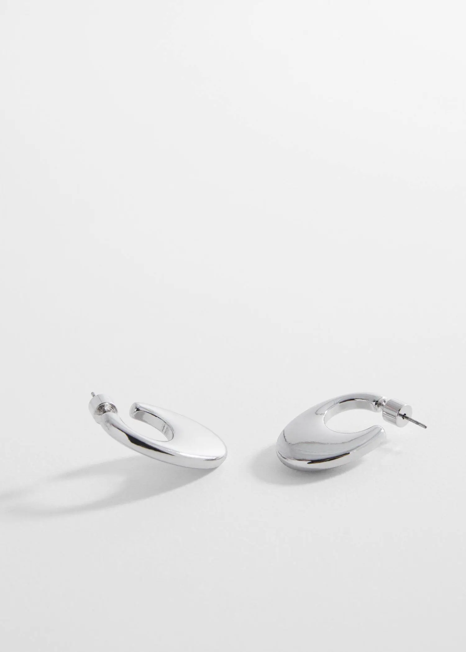 Mango Oval hoop earrings. a close up of a pair of earrings 