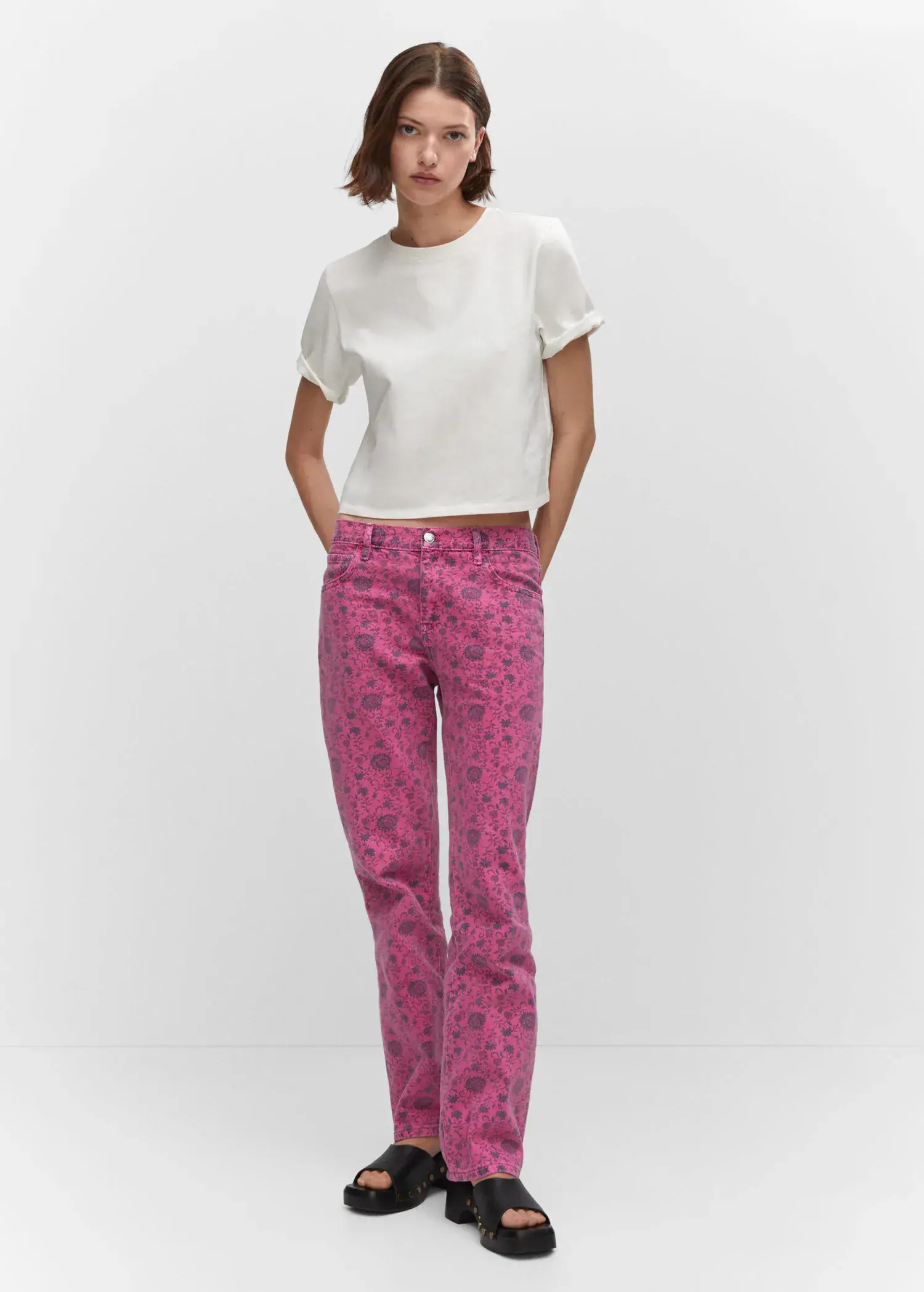 Mango Printed straight jeans. a woman in a white shirt and pink pants. 