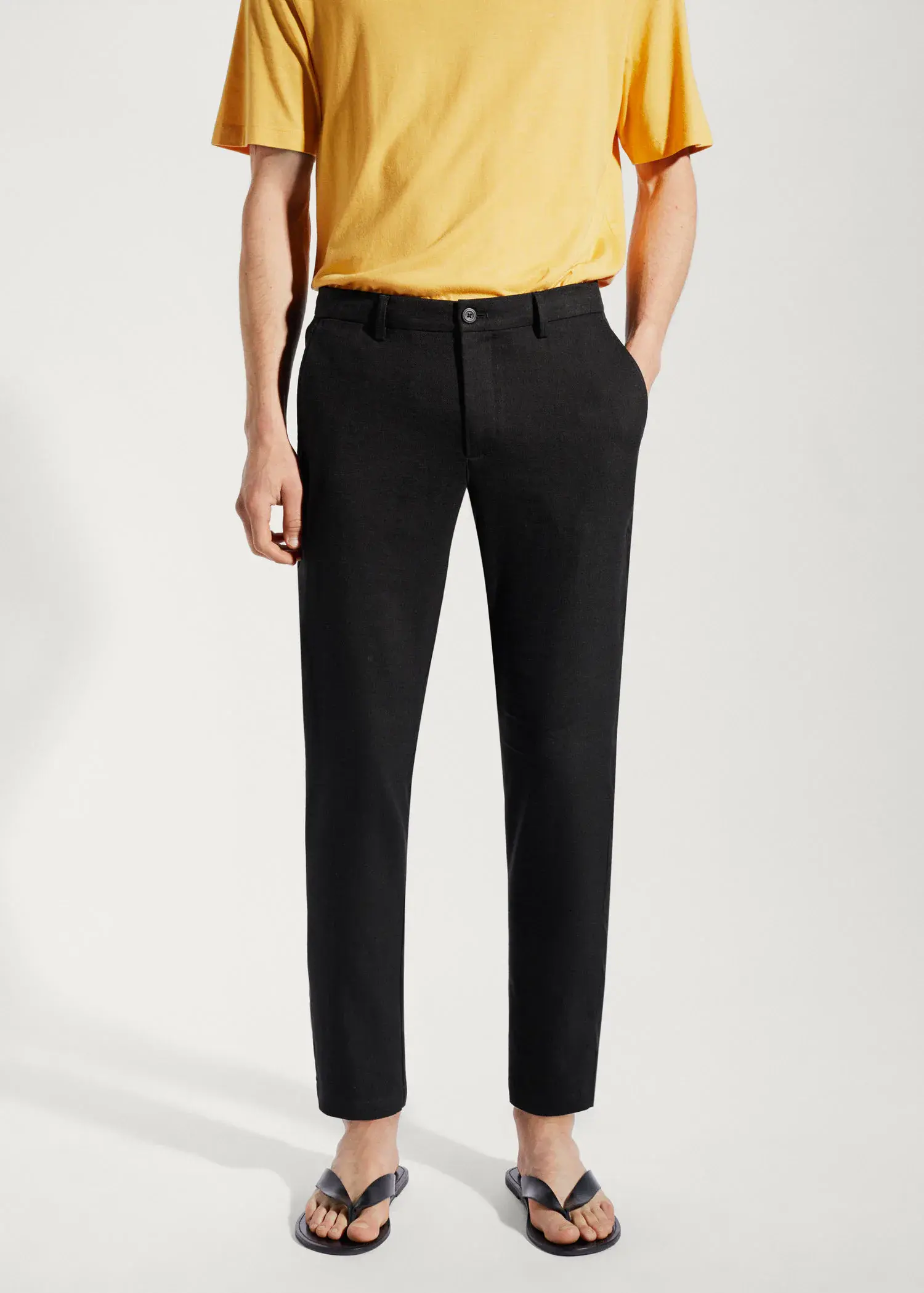 Mango Linen slim-fit trousers with inner drawstring. a man wearing a yellow shirt and black pants. 