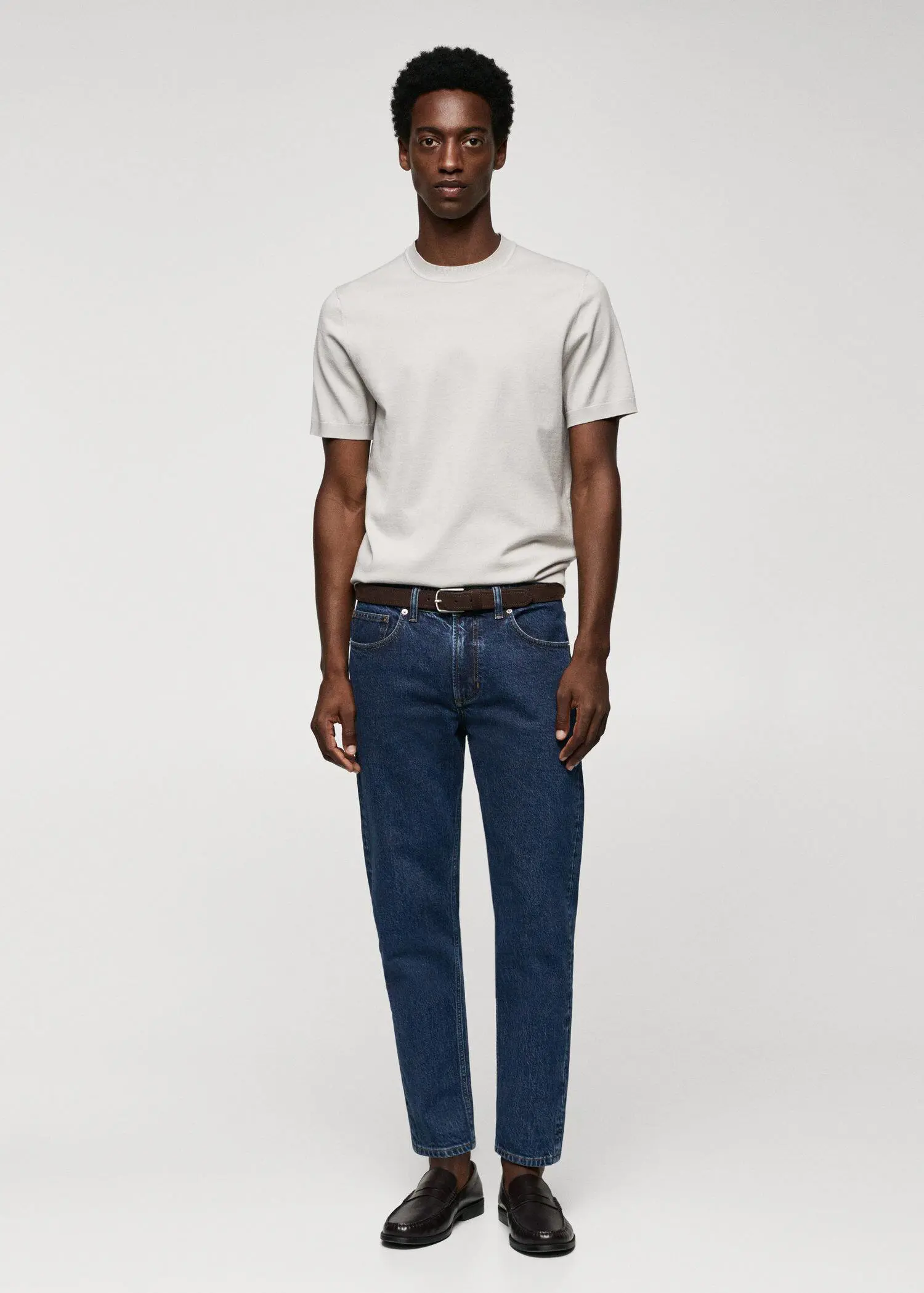 Mango Ben tapered cropped jeans. a man in a white shirt and blue jeans. 