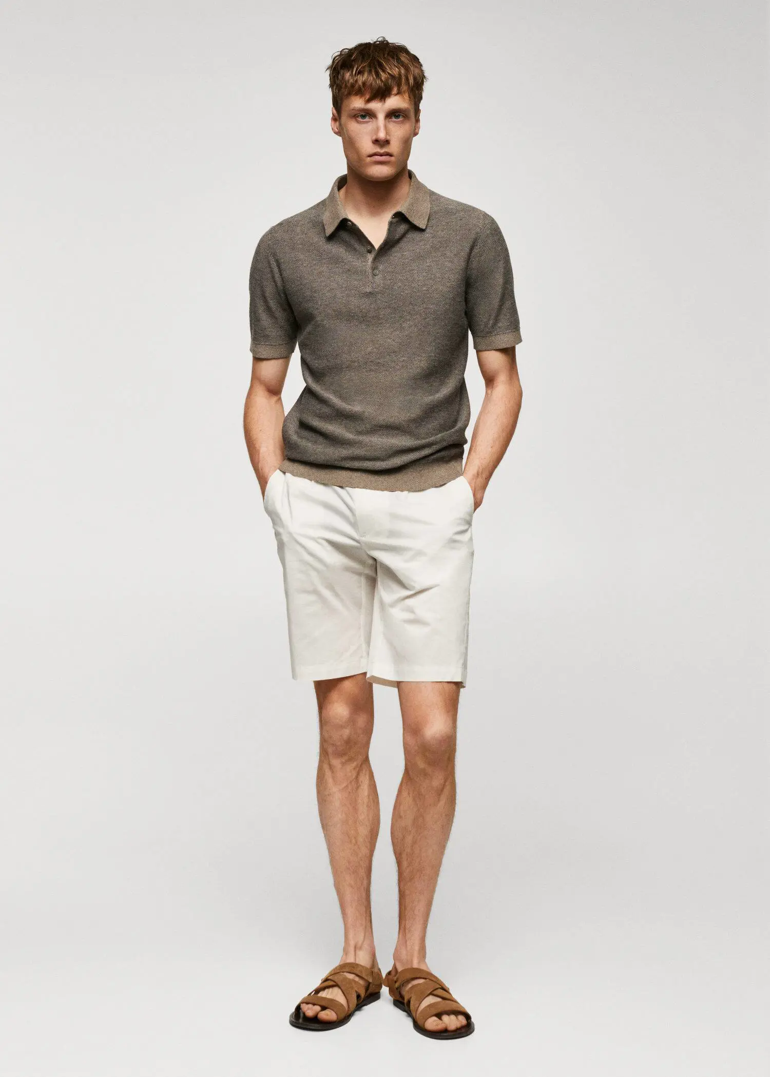 Mango Patterned cotton polo shirt. a man in a brown shirt and white shorts. 