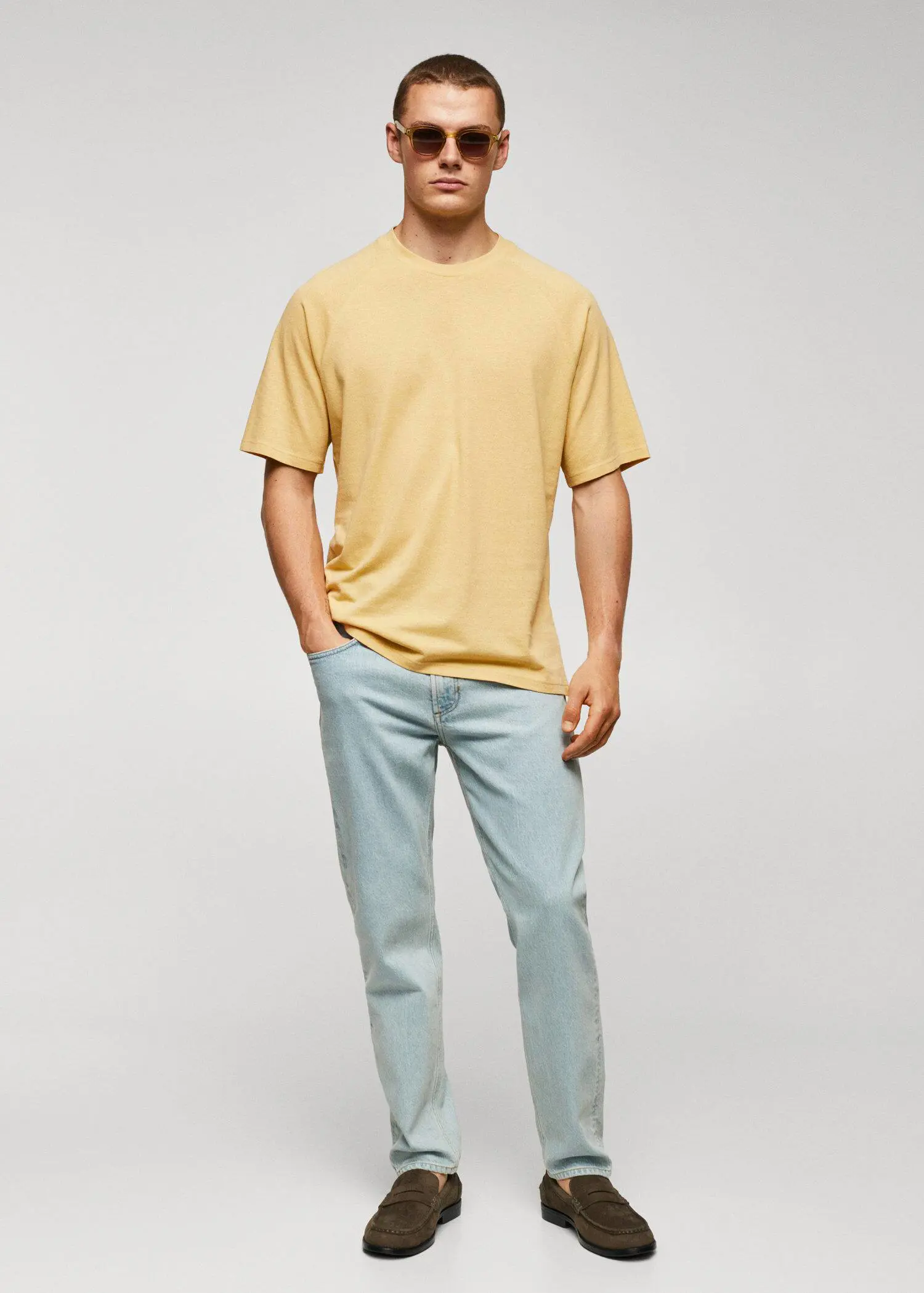 Mango Textured cotton-linen t-shirt. a man standing in front of a white wall. 