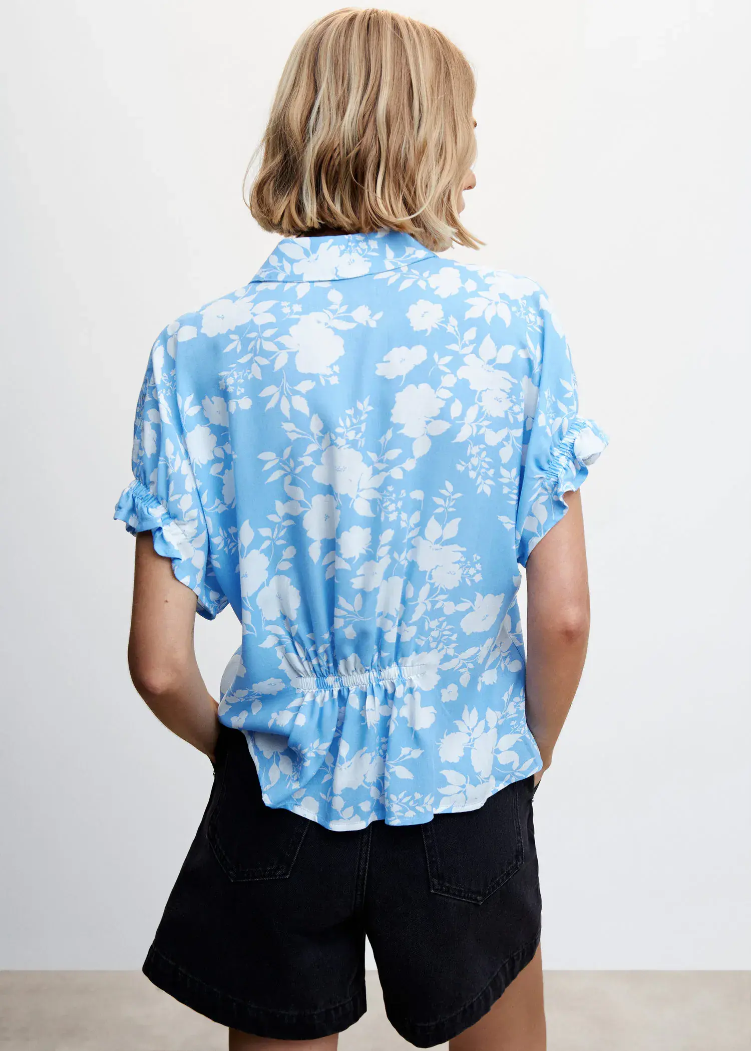 Mango Flowers printed shirt. a woman wearing a blue and white floral shirt. 
