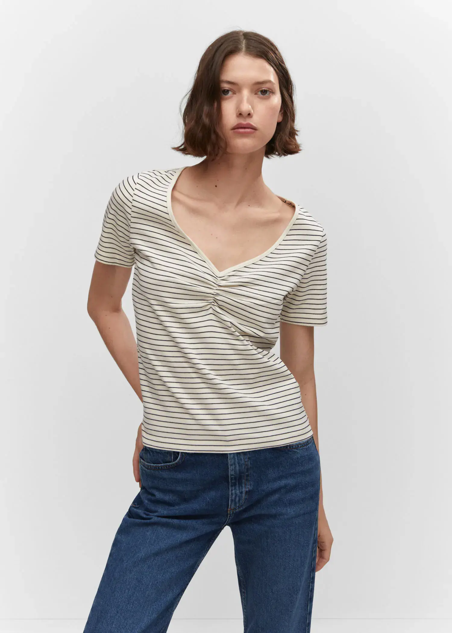 Mango Cotton t-shirt with pucker detail. a woman wearing a white and black striped t-shirt. 
