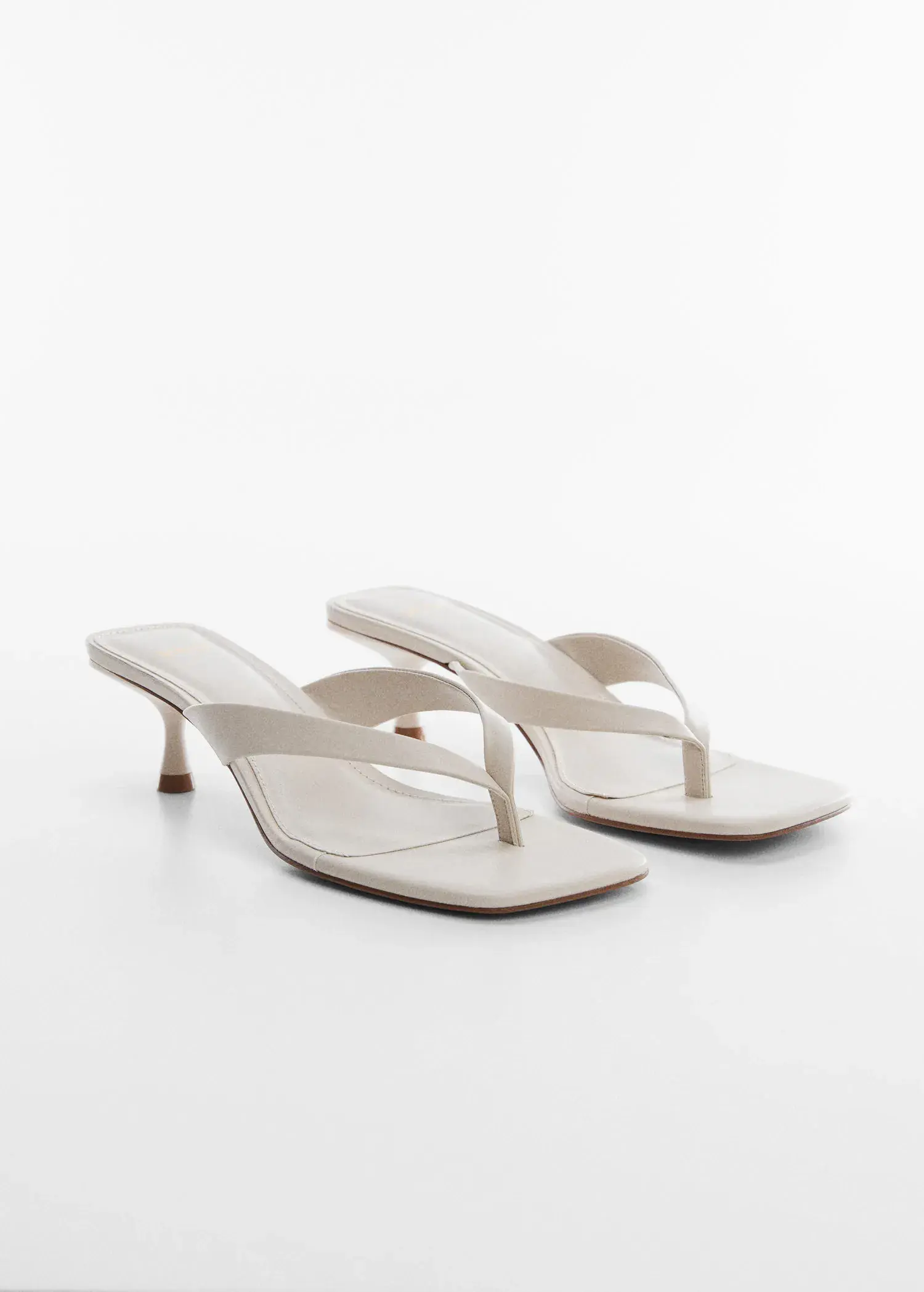 Mango Kitten heel sandals. a pair of white sandals on a white surface. 