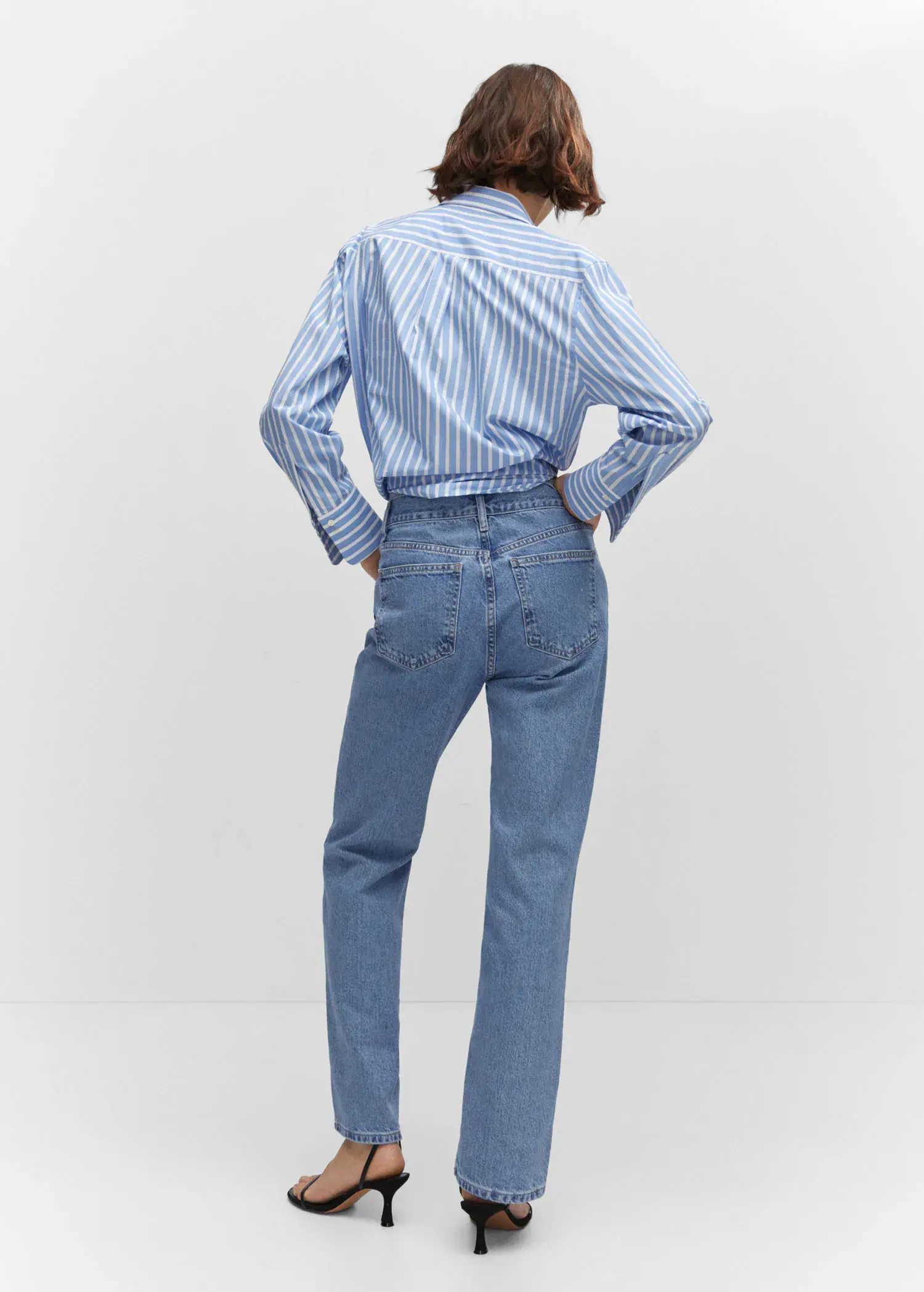Mango Mid-rise straight jeans. a woman wearing a striped shirt and blue jeans. 