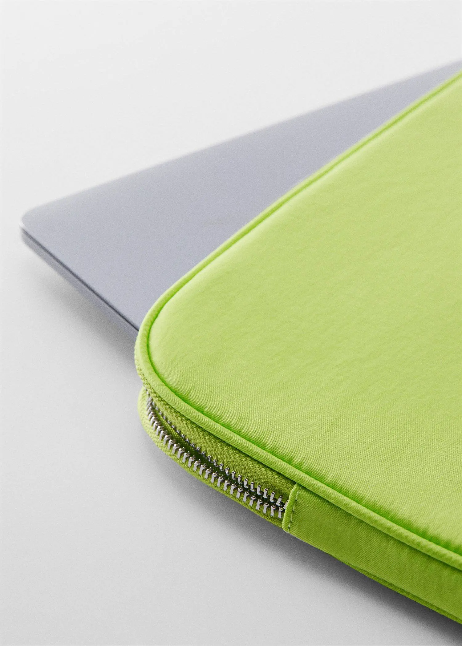 Mango Double-compartment laptop case. a close-up of a lime green laptop case. 