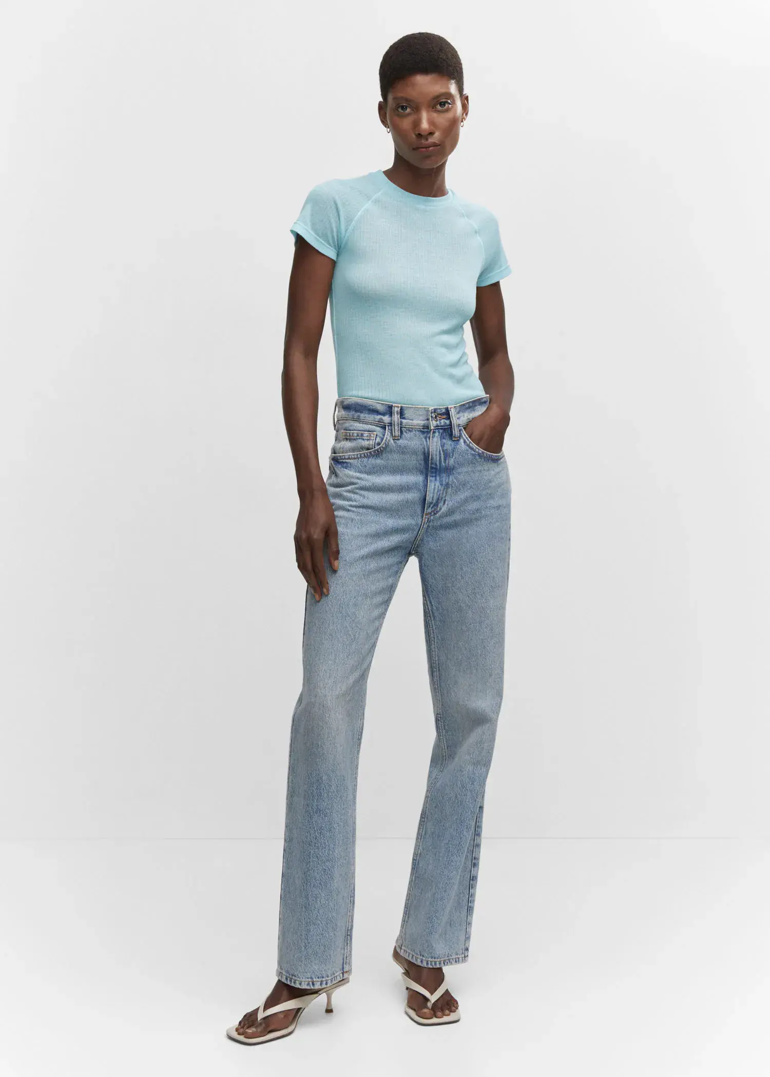 Mango Seam detail T-shirt. a woman wearing a light blue shirt and jeans. 