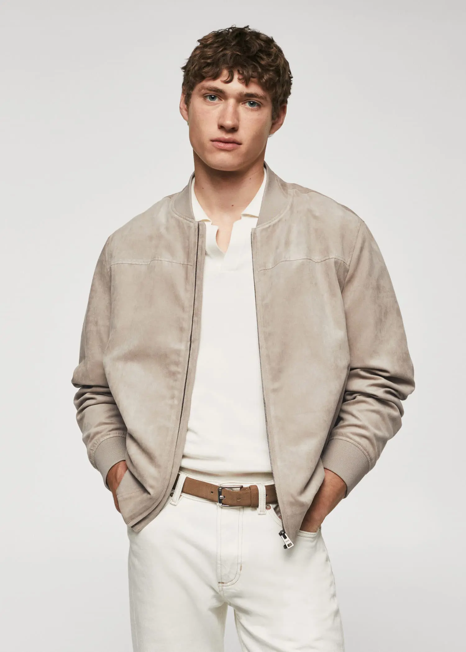 Mango Suede-effect bomber jacket. a young man wearing a beige jacket and white pants. 
