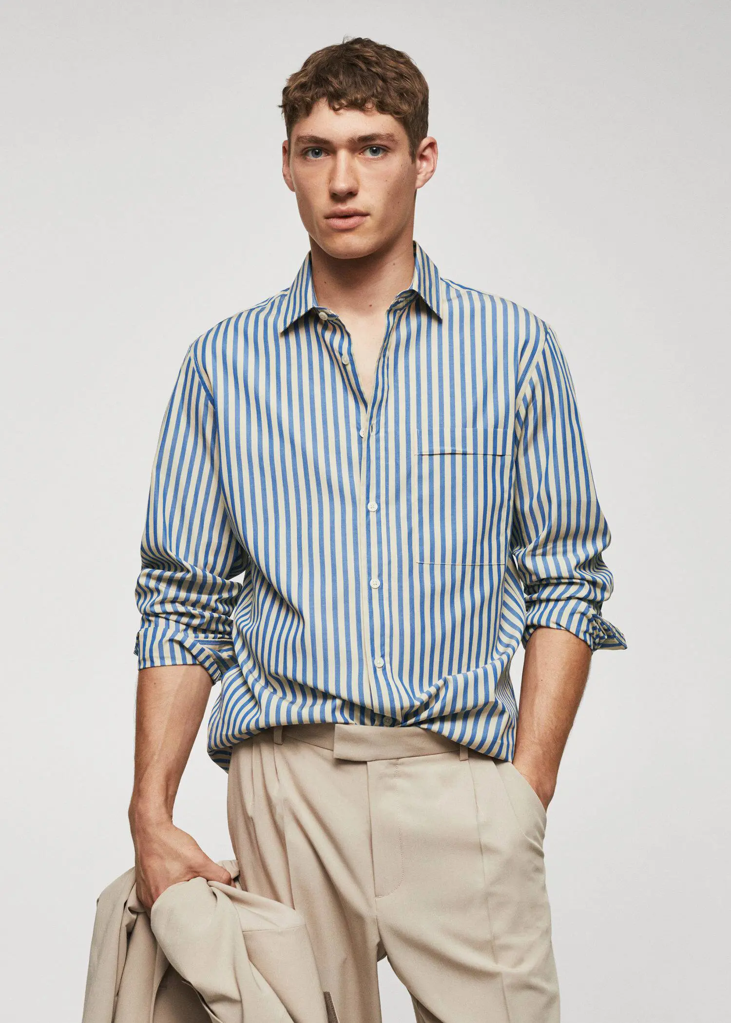 Mango 100% cotton Kodak striped shirt . a man in a striped shirt is holding his hands in his pockets. 