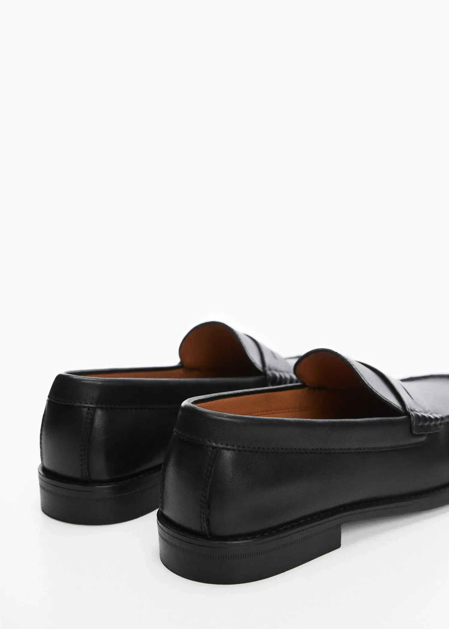 Mango Leather penny loafers. a close up of a pair of shoes on a white surface 