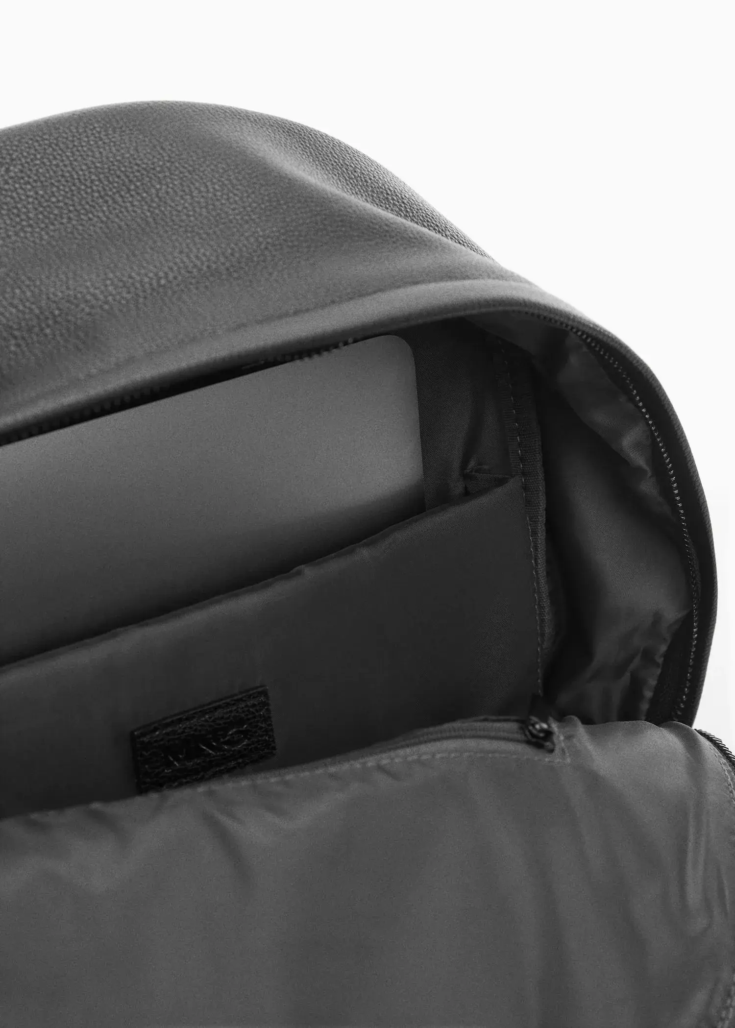 Mango Leather-effect backpack. a close-up view of the inside of a backpack. 