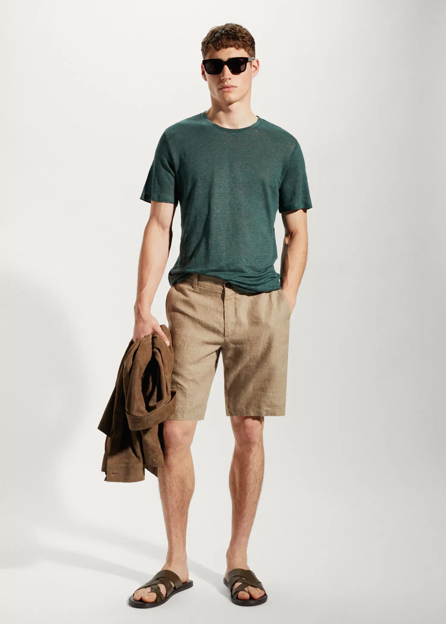 Mango 100% linen slim-fit t-shirt. a young man wearing a green shirt and brown shorts. 