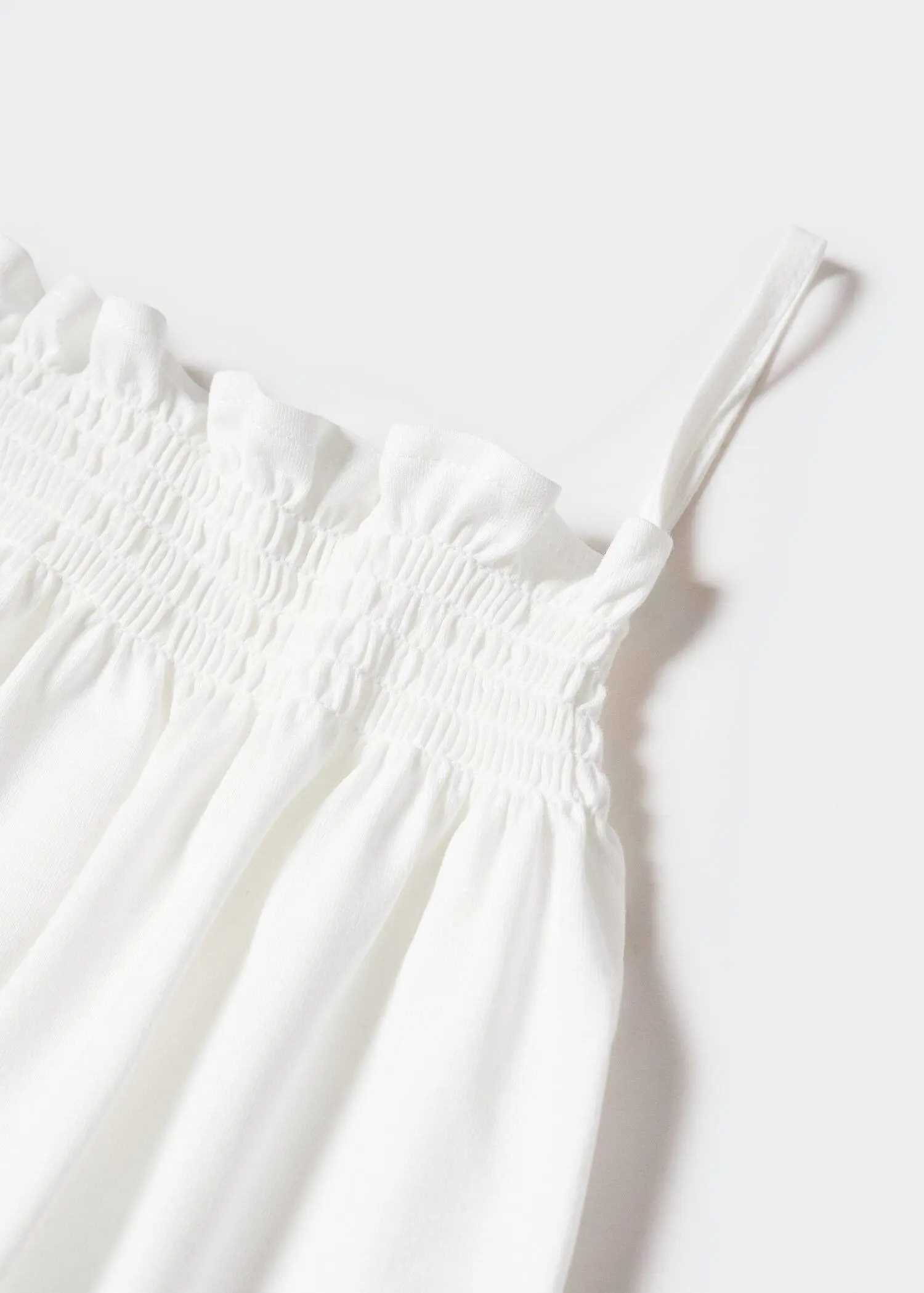 Mango Strap cotton T-shirt. a close-up picture of a white dress. 