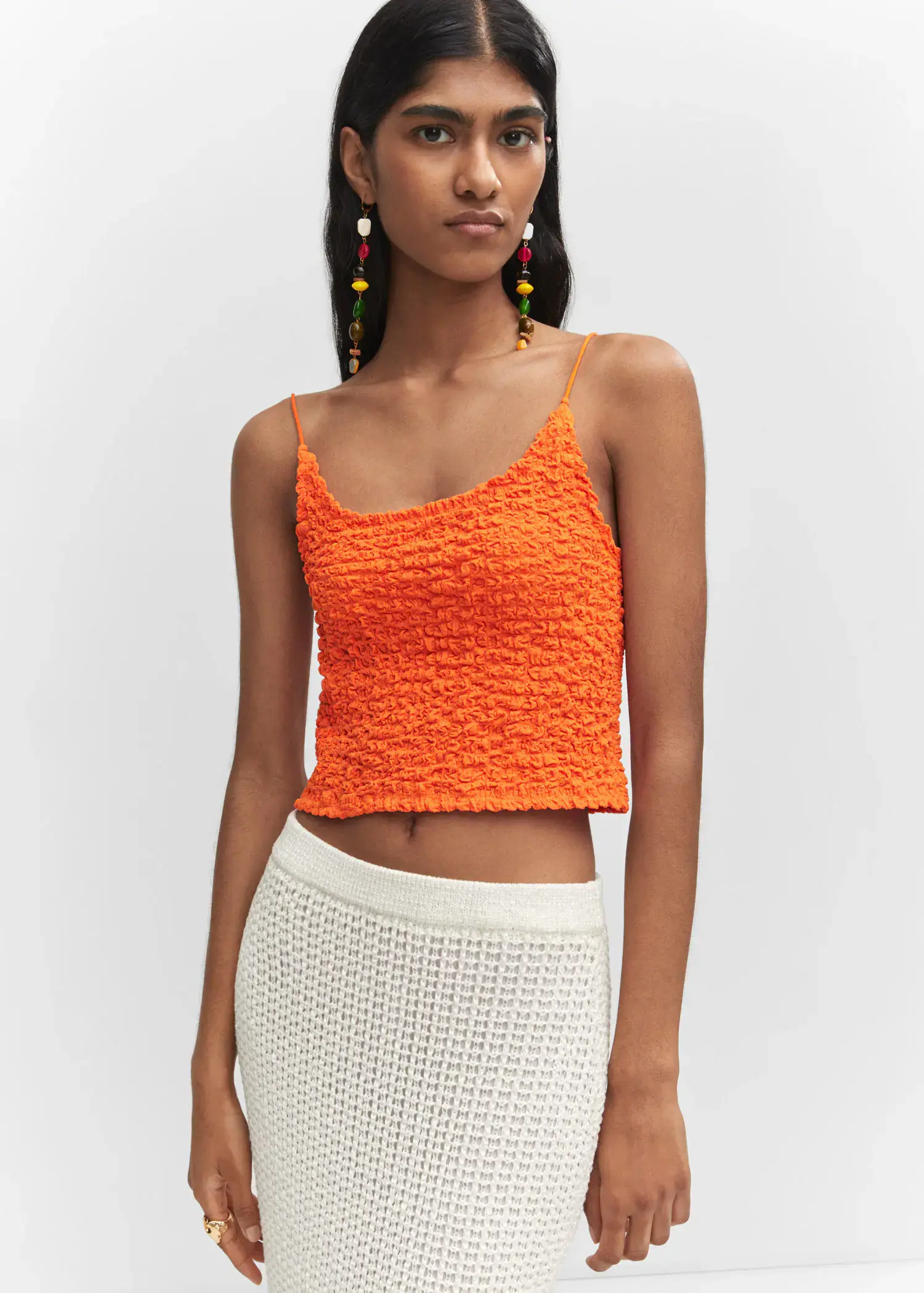 Mango Textured crop top. a woman wearing a white skirt and orange top. 