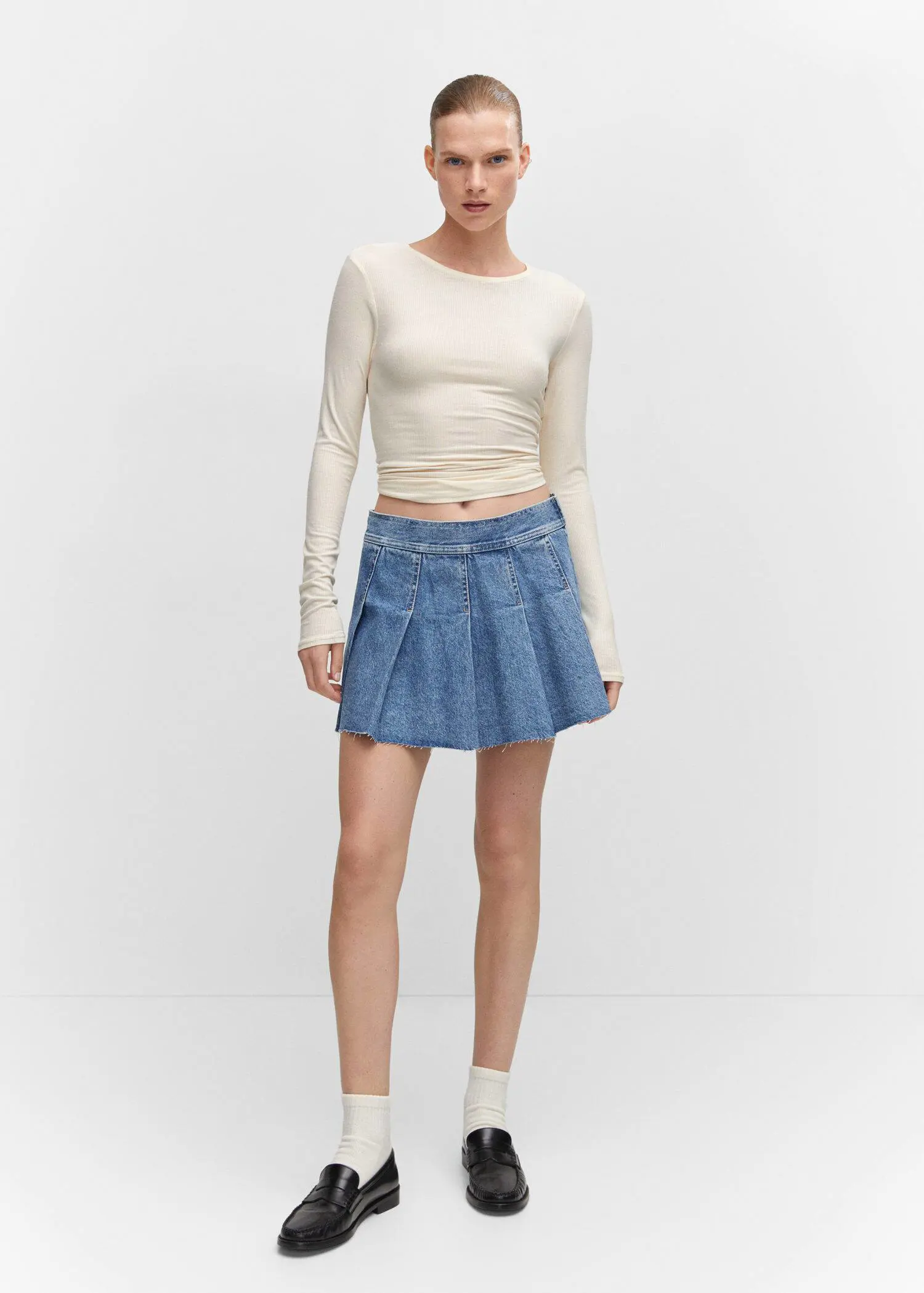 Mango Denim mini-skirt. a woman in a white shirt and a blue skirt 