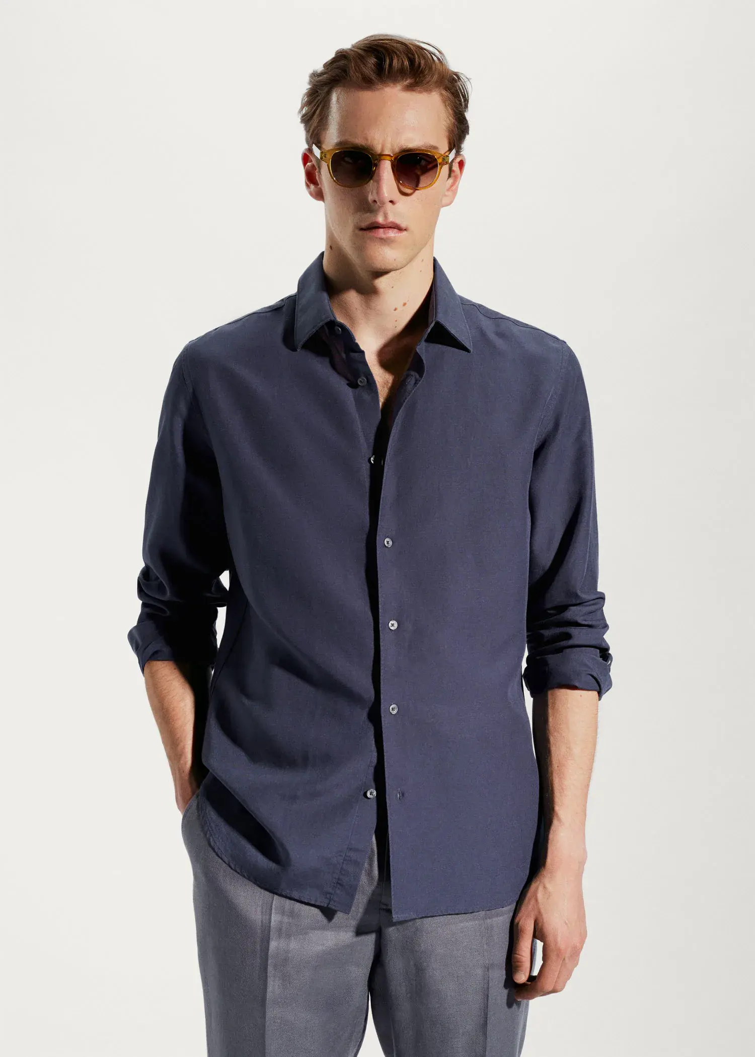 Mango Light tencel-linen shirt. a man wearing a blue shirt and sunglasses. 