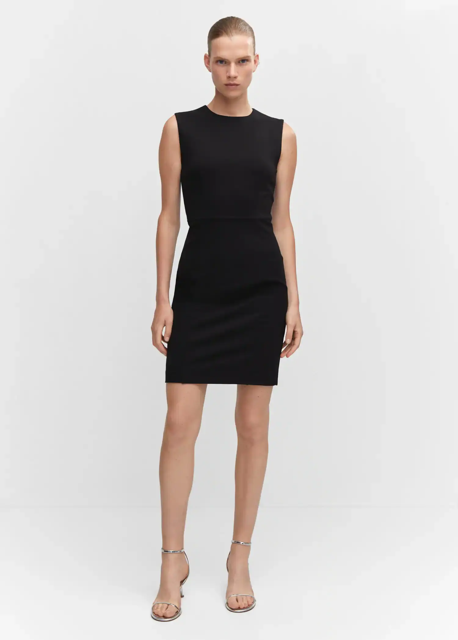 Mango Roma-knit sleeveless dress. a woman wearing a black dress standing in front of a white wall. 