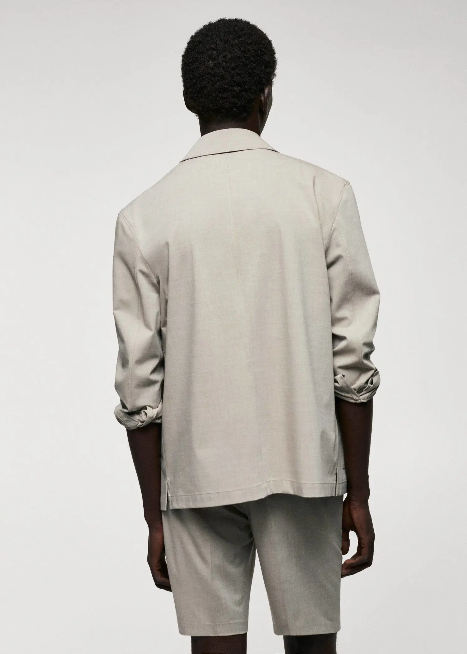 Mango Lightweight pocket jacket. a man in a white shirt is standing in front of a white wall. 