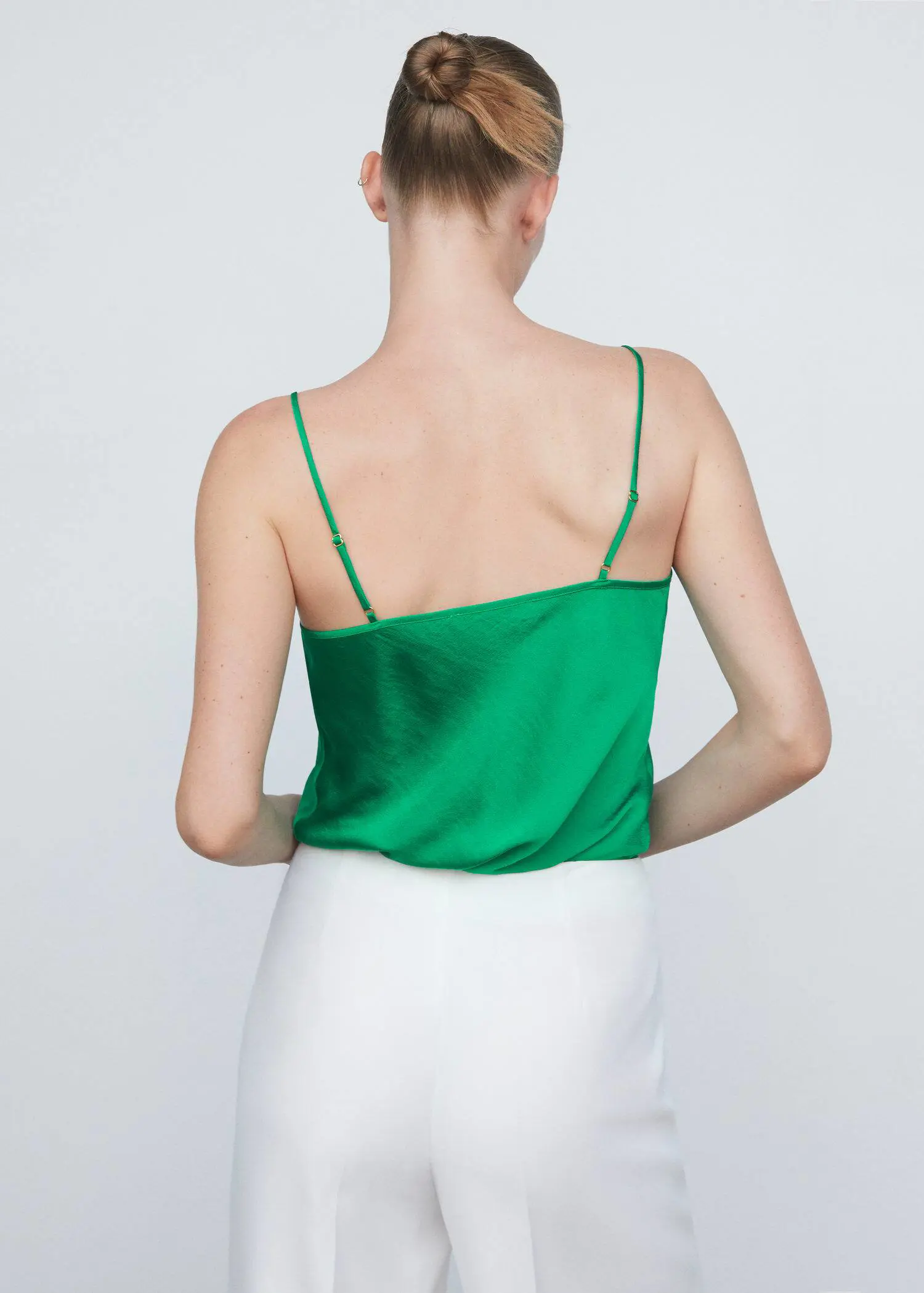 Mango Satin lace top. a woman wearing a green top and white skirt. 