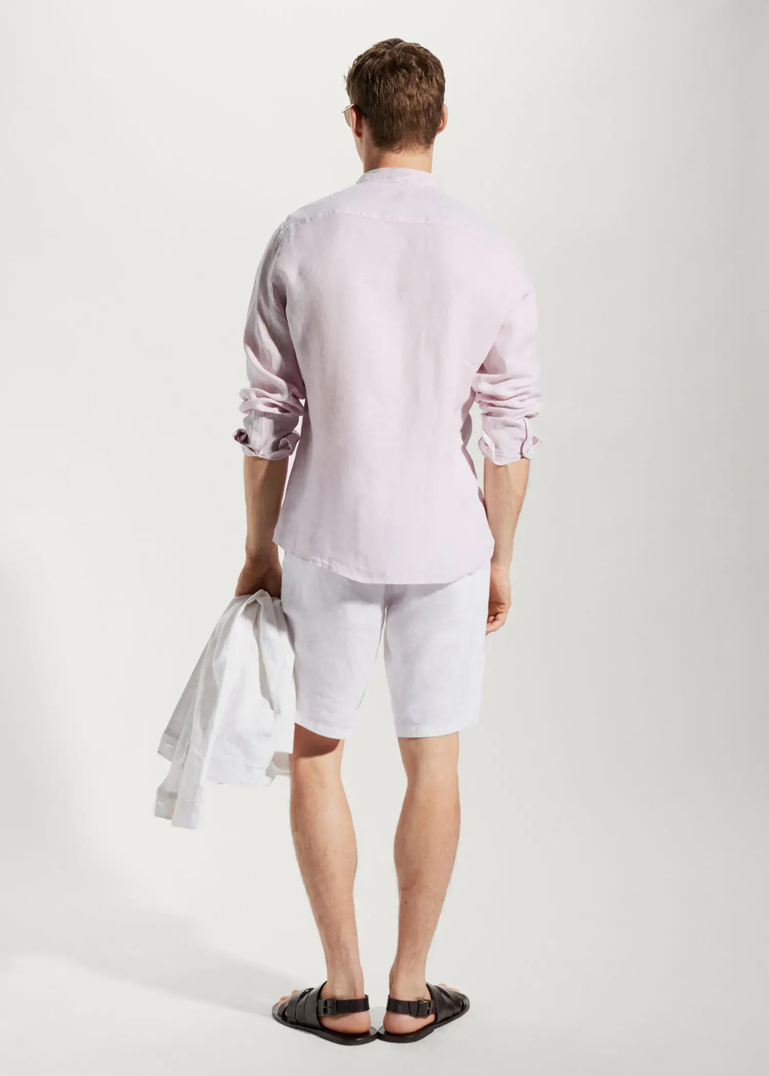 Mango 100% linen Mao collar shirt. a man in white shorts and a light pink shirt. 