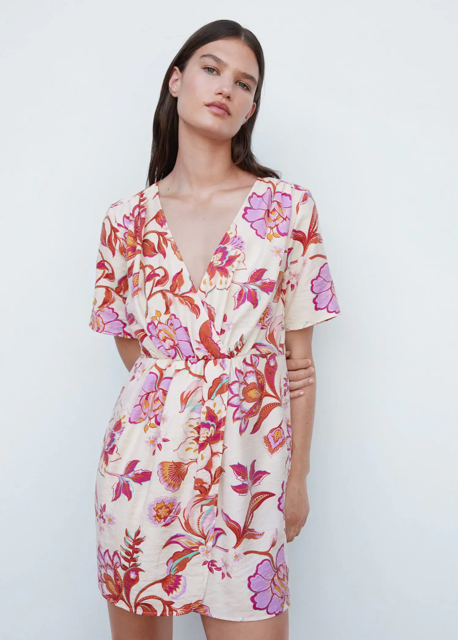 Mango Short printed wrap dress. a woman in a floral dress posing for a picture. 