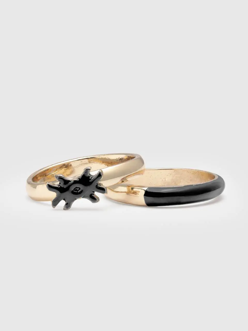 Benetton two rings with black enamelled details. 1