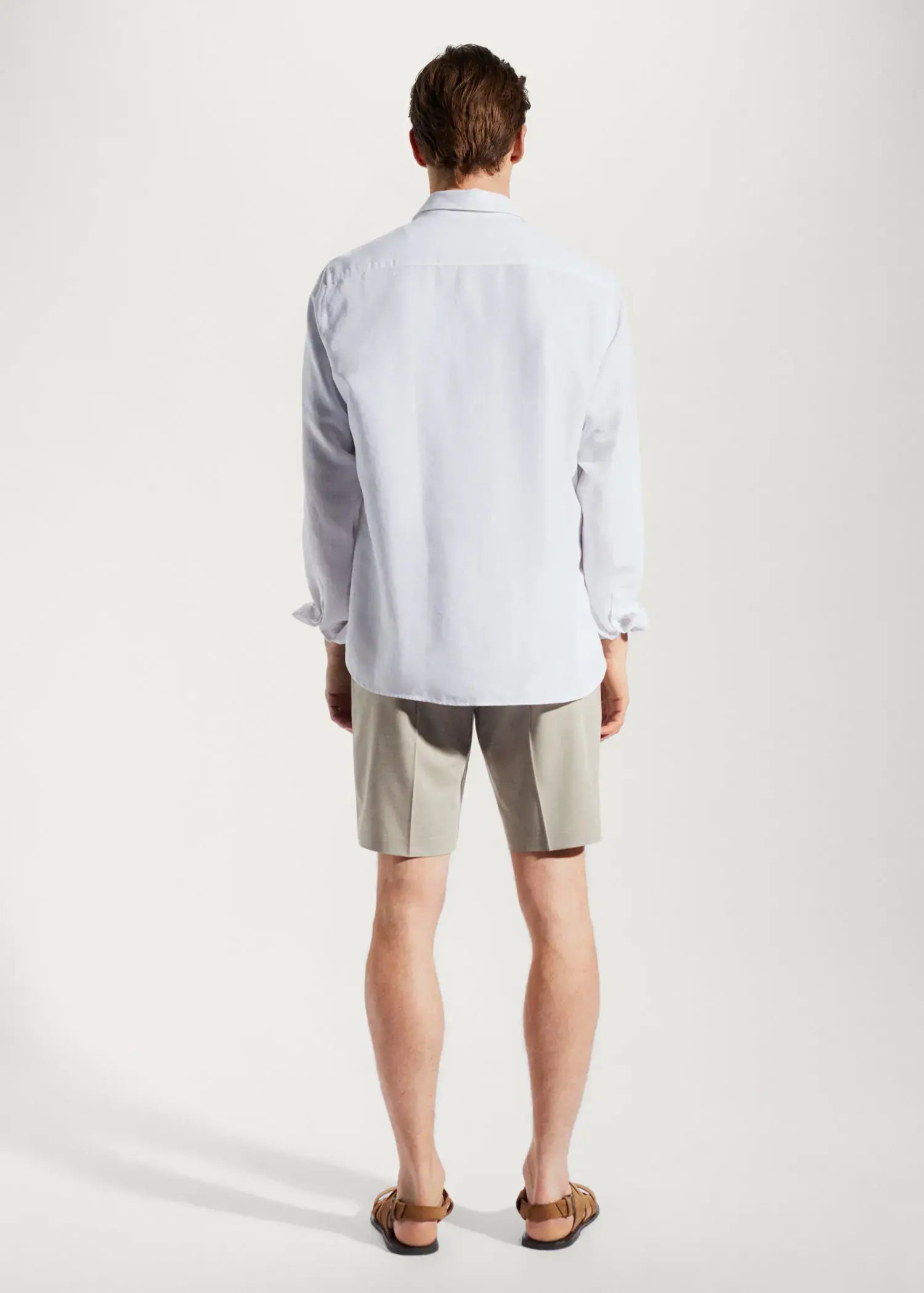 Mango Light tencel-linen shirt. a man wearing a white shirt and shorts. 