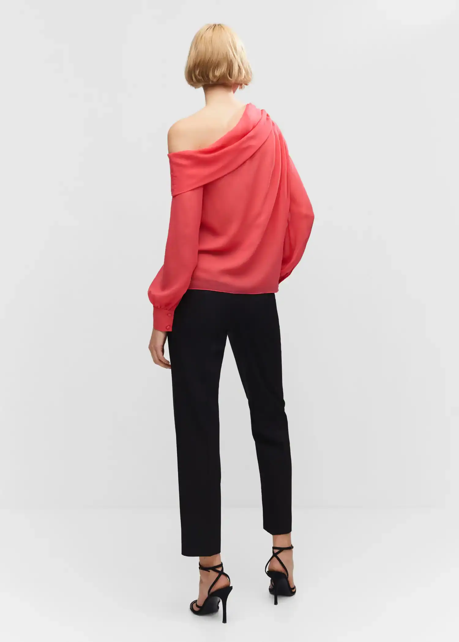 Mango Asymmetrical oversized blouse. a woman wearing a red top and black pants. 