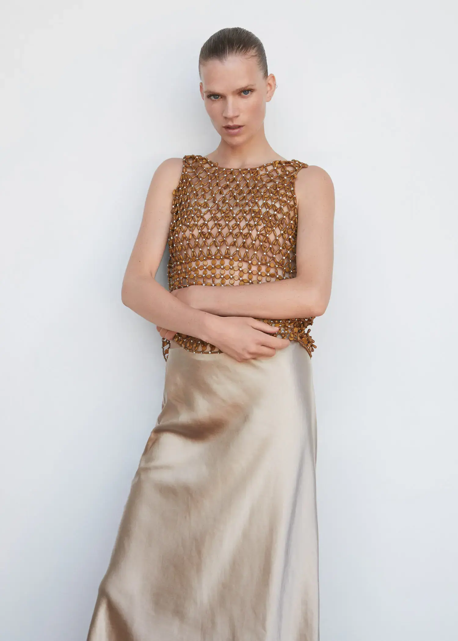 Mango Beaded open-work top. a woman in a gold dress posing for a picture. 