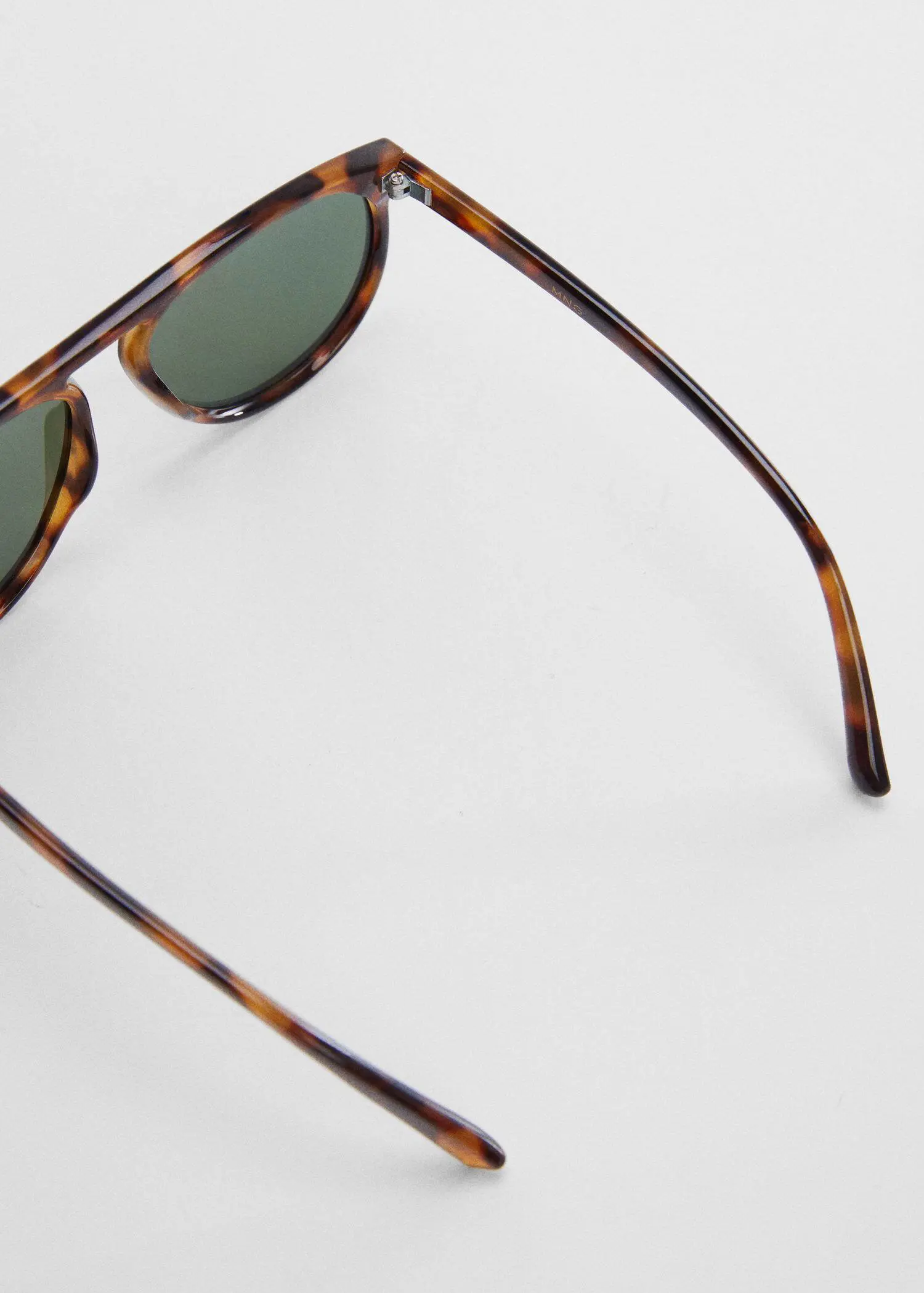 Mango Polarised sunglasses. a close up of a pair of sunglasses on a white surface 